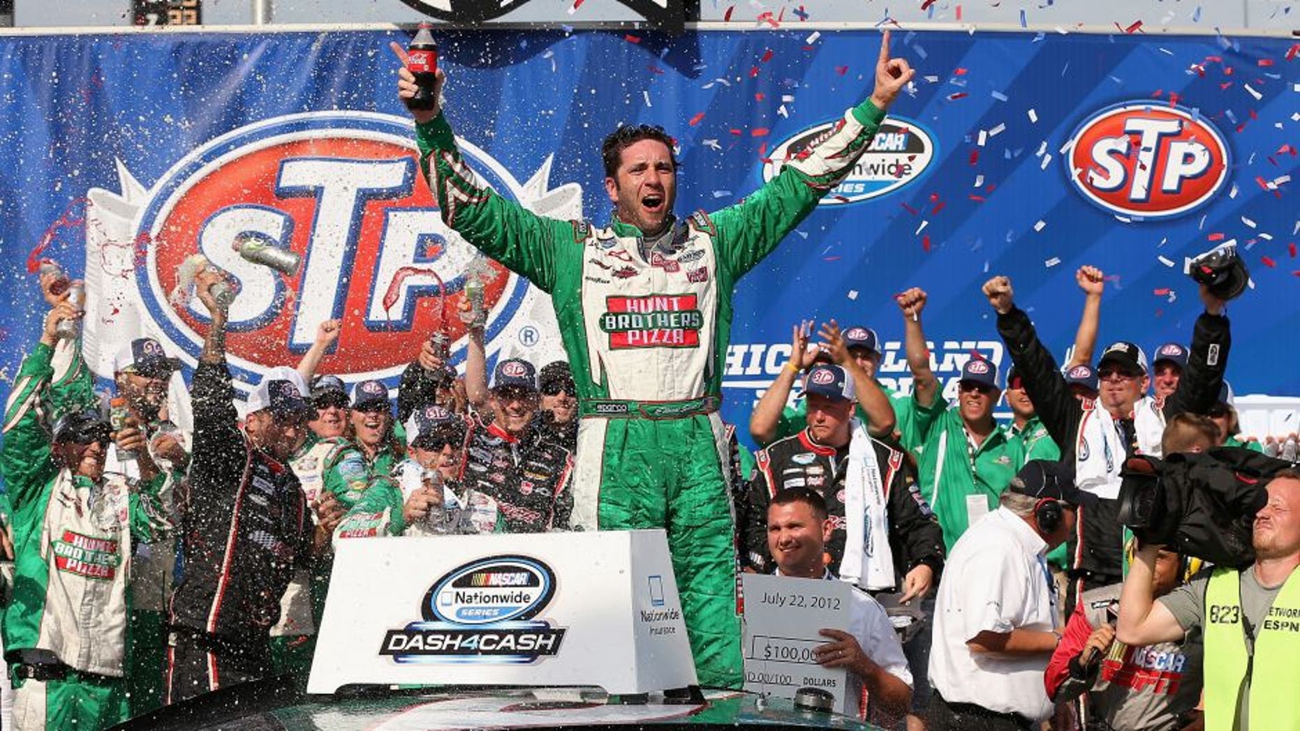 JOLIET, IL - JULY 22: Elliott Sadler, driver of the #2 Hunt Brothers Pizza Chevrolet, celebrates winning the NASCAR Nationwide Series STP 300 at Chicagoland Speedway on July 22, 2012 in Joliet, Illinois. (Photo by Jonathan Daniel/Getty Images)