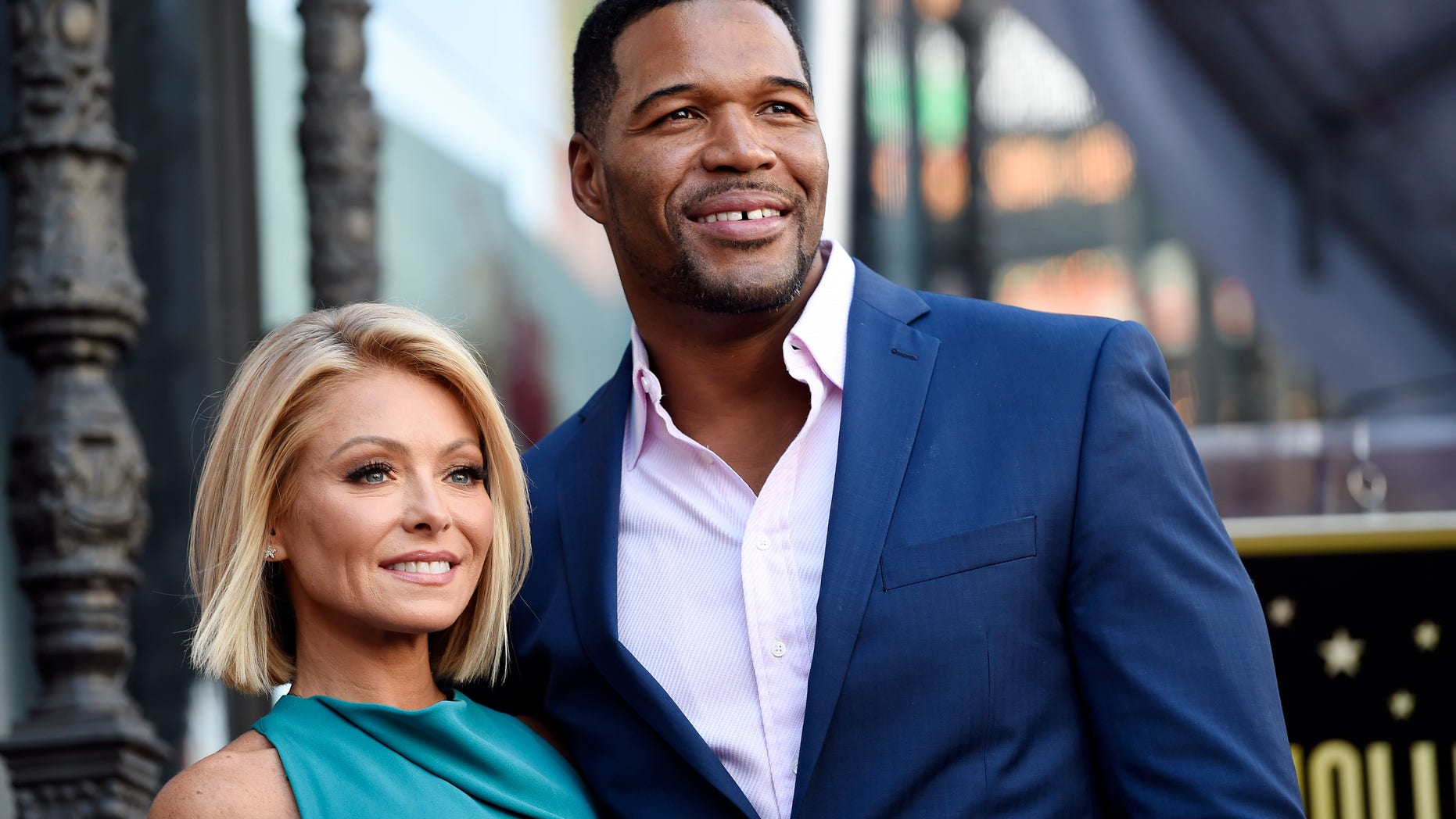 Kelly Ripa and Michael Strahan pose during a ceremony honoring Ripa with a star on the Hollywood Walk of Fame in 2015.