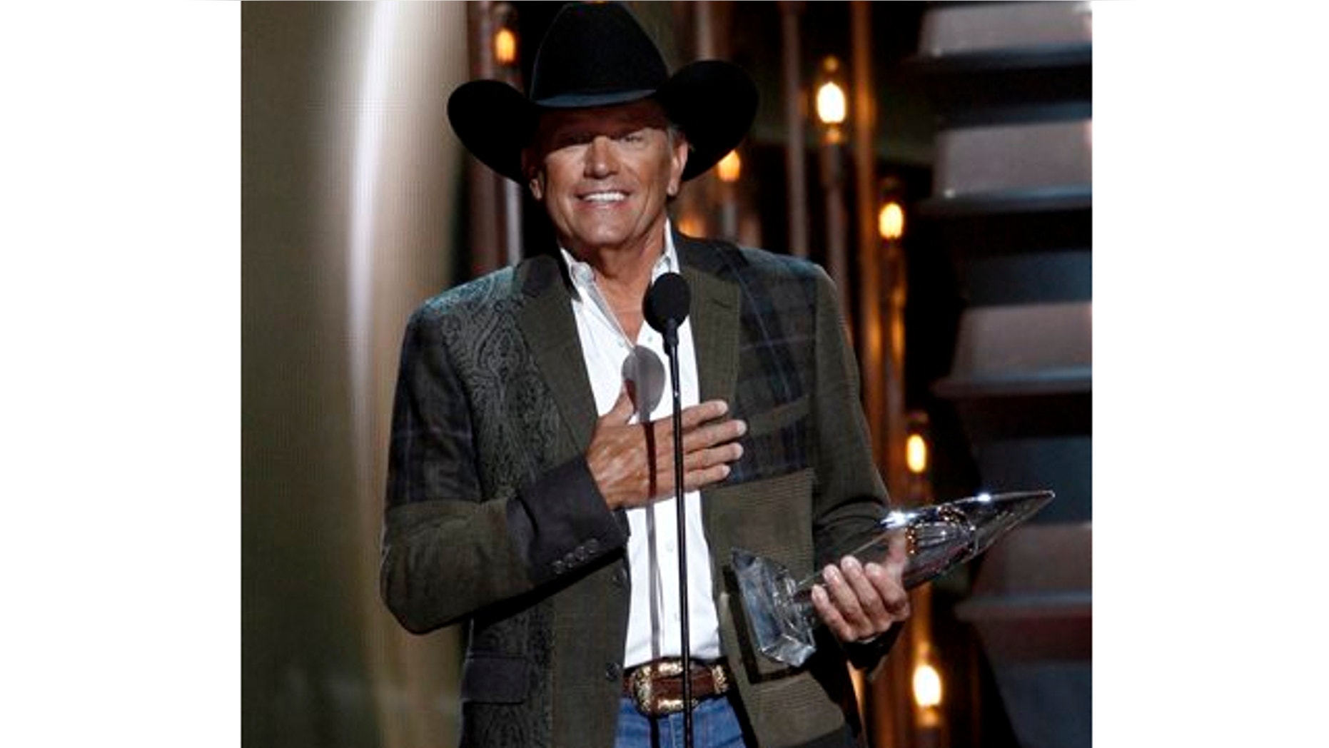 Nov. 6, 2013: George Strait accepts the award for entertainer of the year at the 47th annual CMA Awards at Bridgestone Arena in Nashville, Tenn.