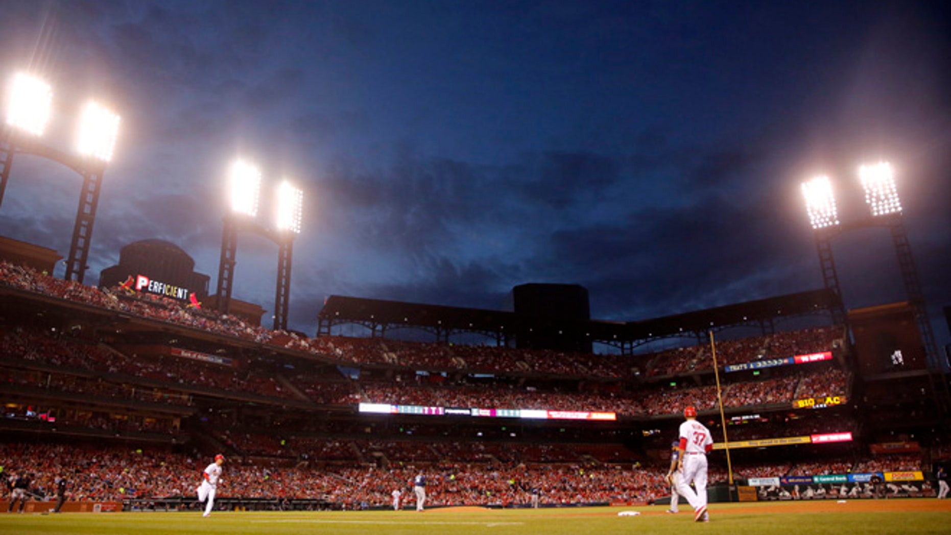 St. Louis Cardinals' Stephen Piscotty heads to first on a single as dusk falls over Busch Stadium during the fourth inning of a baseball game against the Milwaukee Brewers Tuesday, May 2, 2017, in St. Louis. (AP Photo/Jeff Roberson)