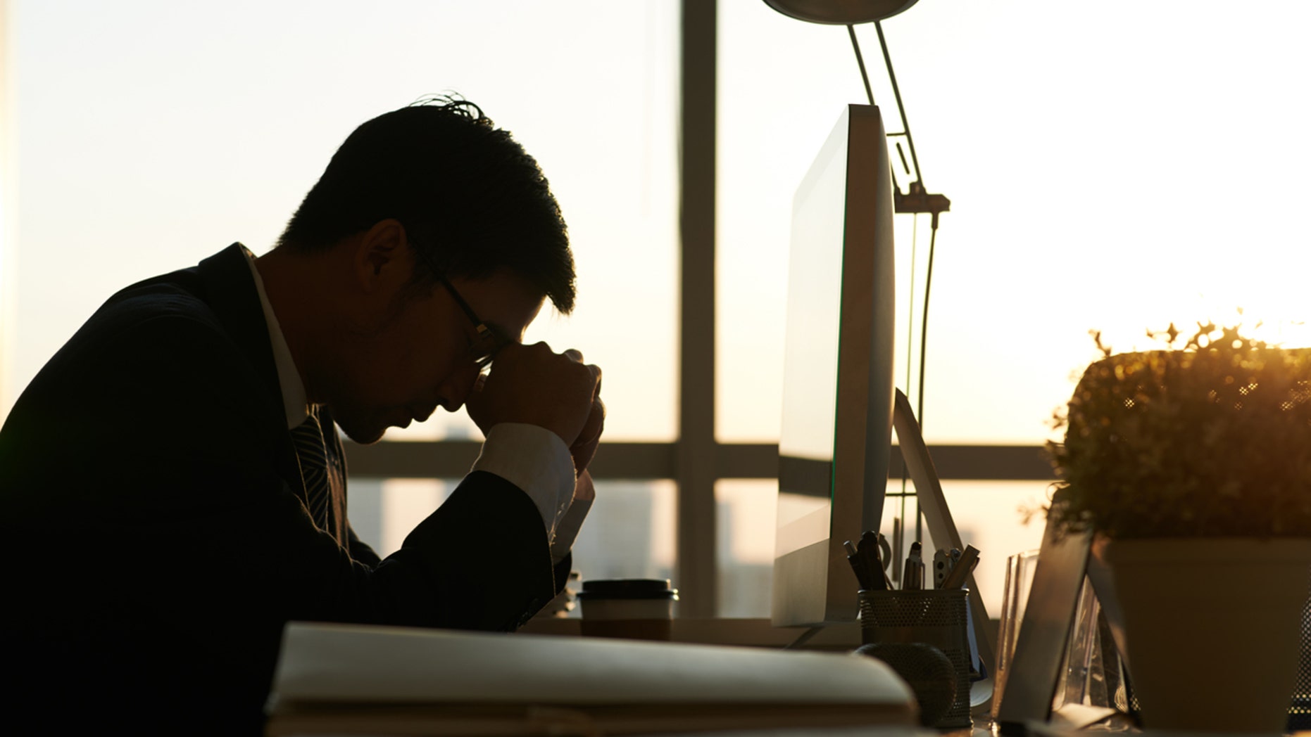 Exhausted businessman having moment of rest in office