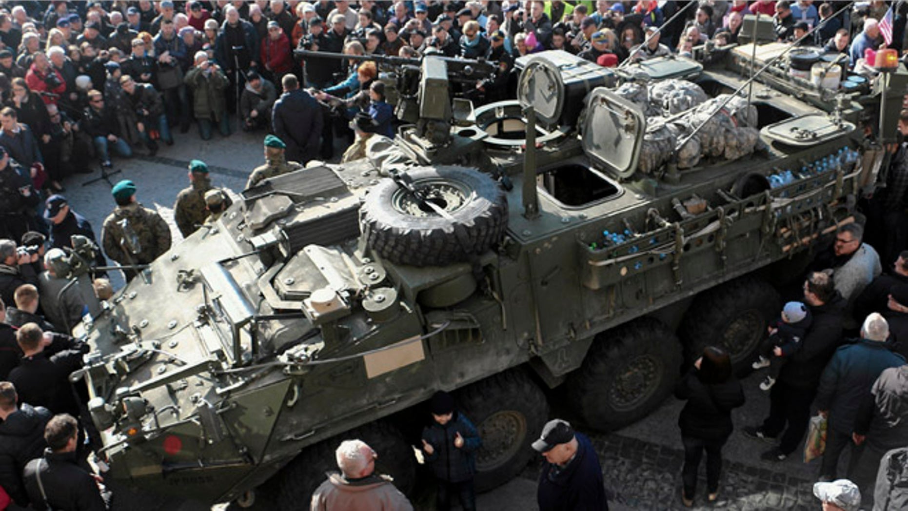 March 24, 2015: People gather around an U.S. Army 2nd Cavalry Regiment "Stryker" armored fighting vehicle in Bialystok, Poland, which is a part of the U.S. military "Dragoon Ride" operation. Dragoon Ride is aimed at demonstrating commitment to NATO allies in light of Russia's aggression in Ukraine, according to the U.S. Army.