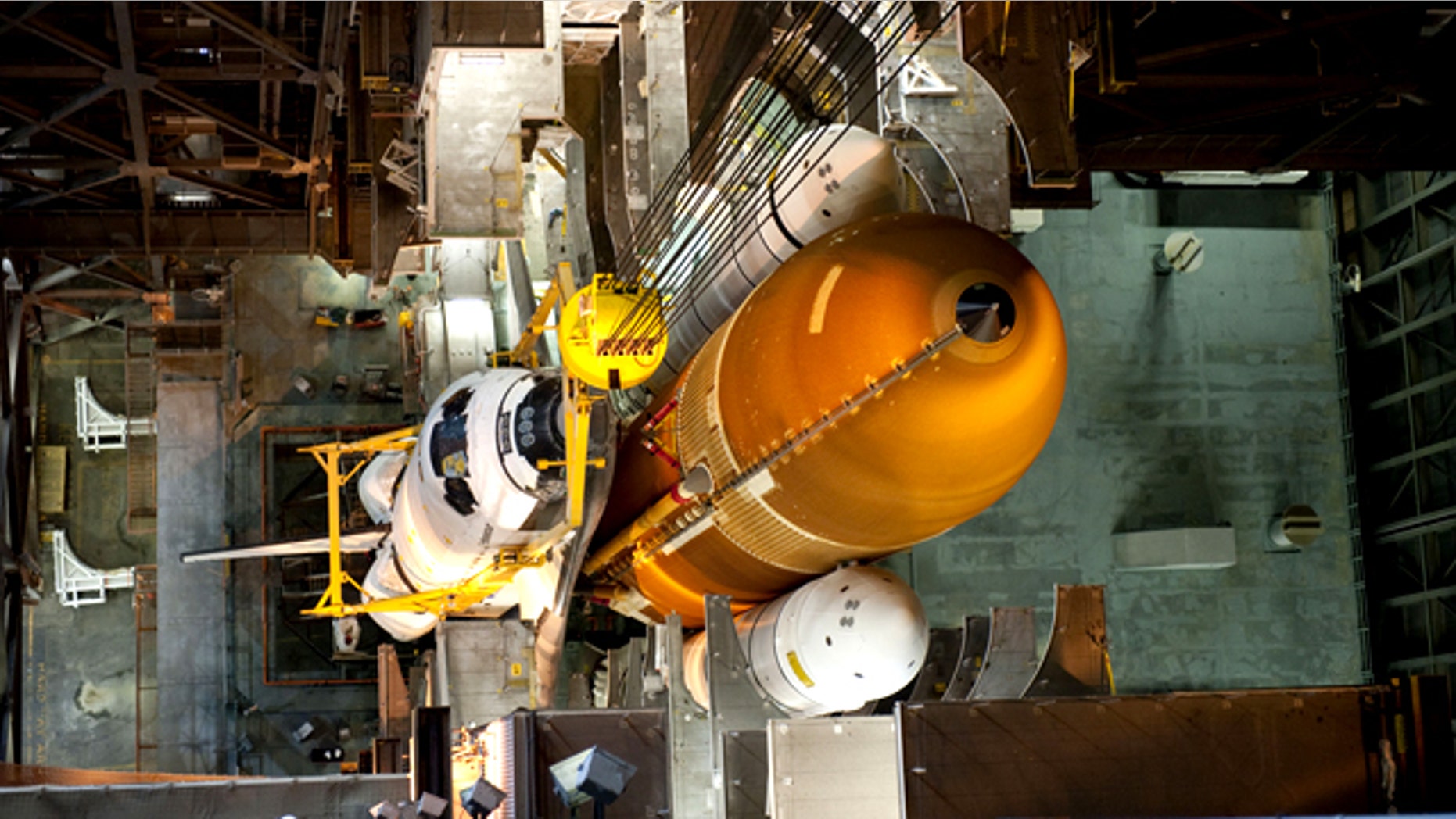 In the Vehicle Assembly Building at NASA's Kennedy Space Center in Florida, shuttle Endeavour is lowered into place where it is being attached to its external fuel tank and solid rocket boosters, already positioned on the mobile launcher platform. The shuttle is slated to launch its final mission STS-134 on April 19, 2011.