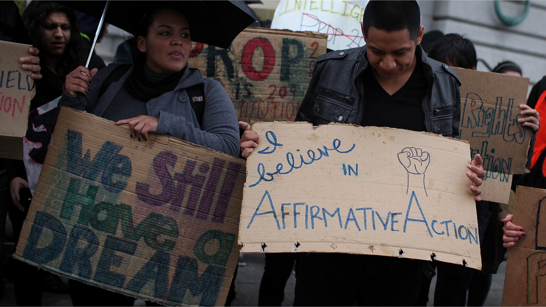 Students hoping for a repeal of California's Proposition 209 hold signs as they protest outside of the Ninth U.S. Circuit Court of Appeals.