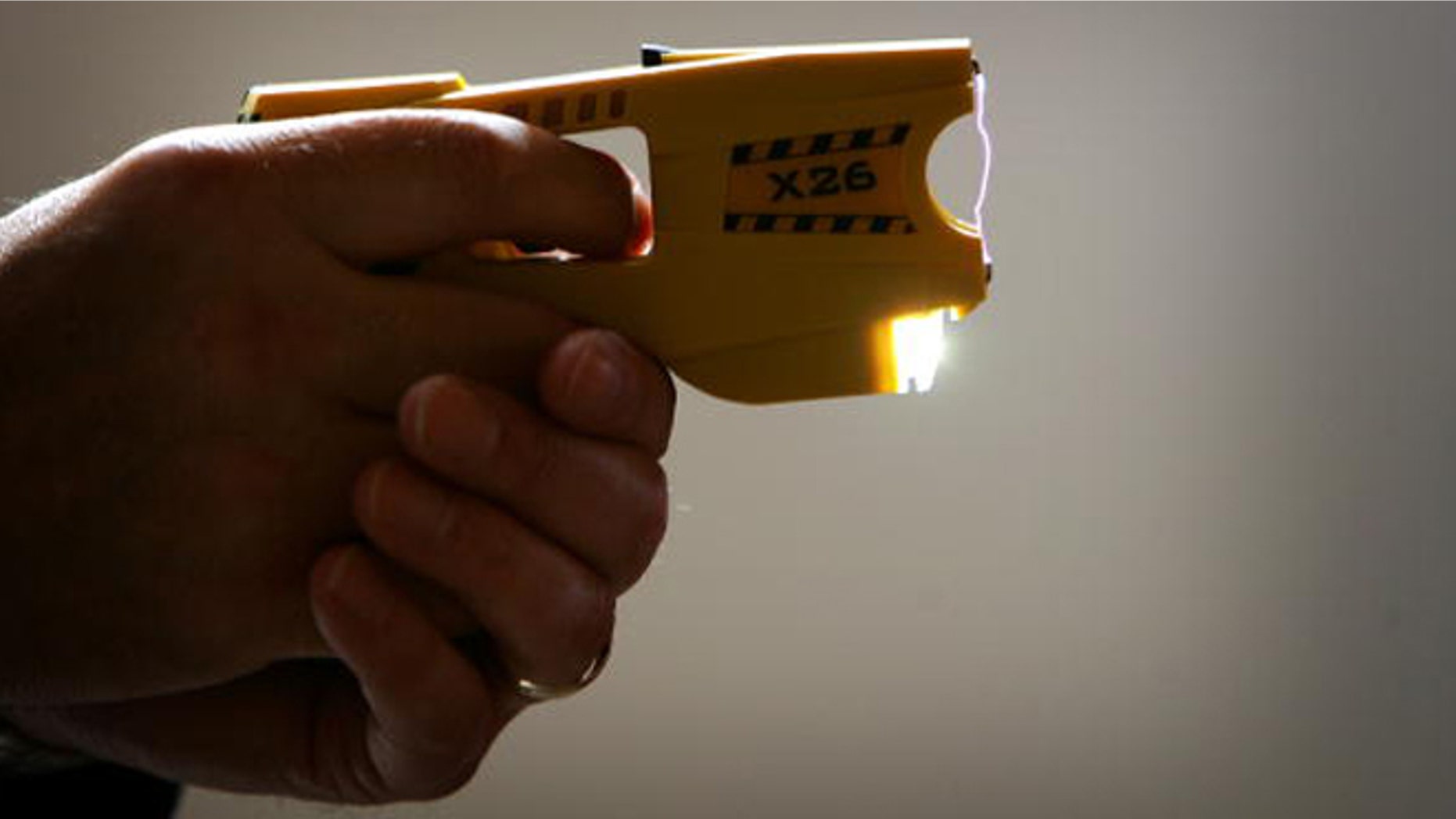 BLACKPOOL, UNITED KINGDOM - MAY 16: A representative from Taser International fires the companies latest X26 stun gun during the Police Federation Conference at Winter Gardens on May 16, 2007 in Blackpool, England. British Home Secretary John Reid announced today that more Taser guns could be deployed on the streets of the UK by frontline police officers. The Taser's which stun a person with up to 50,000 volts, and can currently only be carried by armed response officers have some under harsh criticism from Amnesty International who claim more than 70 deaths in Canada and America have been linked to the weapon. (Photo by Christopher Furlong/Getty Images)