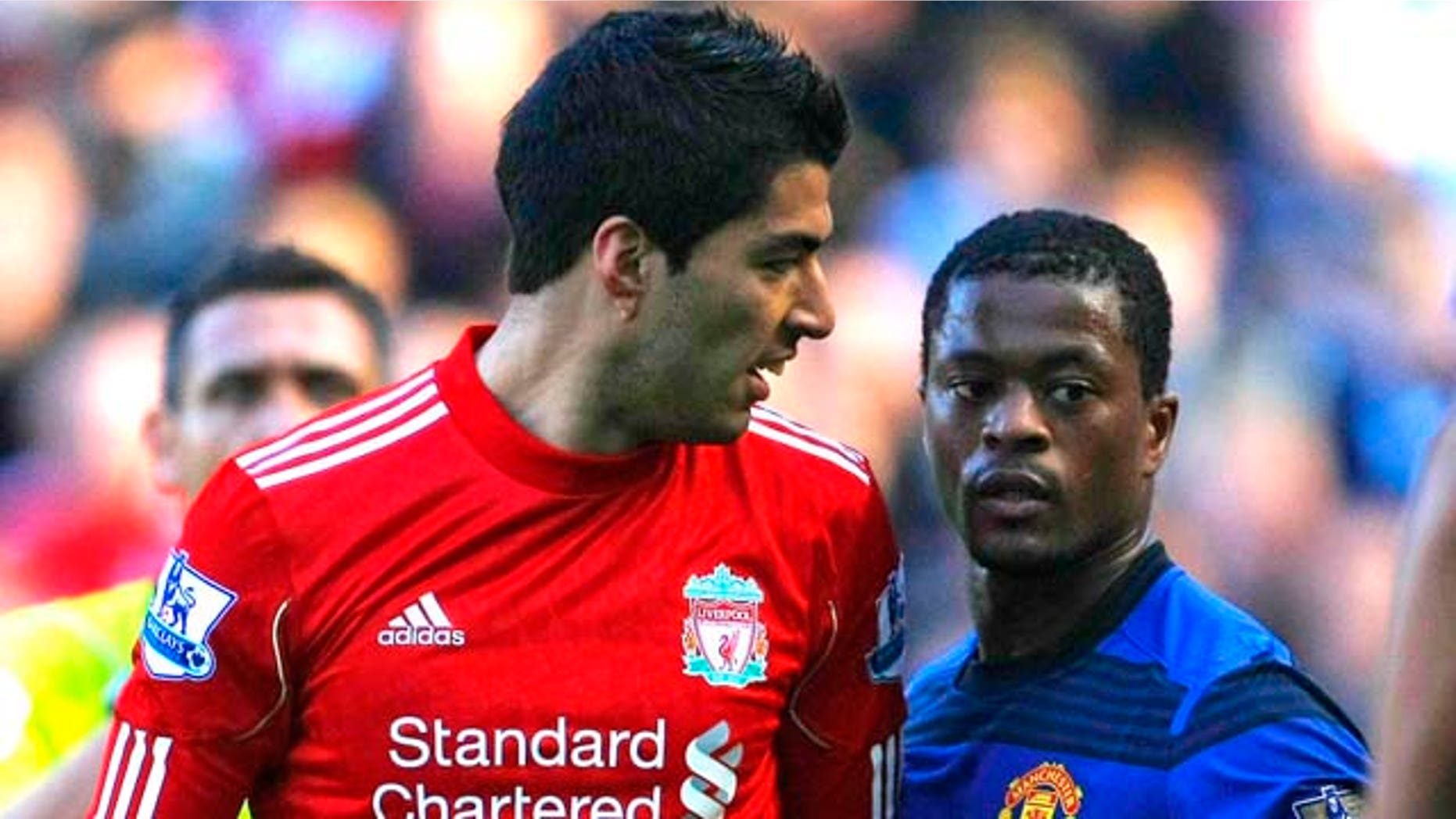 In this photo taken Saturday, Oct. 15, 2011, Manchester United's Patrice Evra argues with Liverpool's Luis Suarez, left, during their English Premier League soccer match at Anfield, Liverpool, England. The English Football Association has launched an investigation into allegations from Manchester United's Patrice Evra that he was racially abused by Liverpool striker Luis Suarez during Saturday's Premier League match. (AP Photo/Tim Hales)