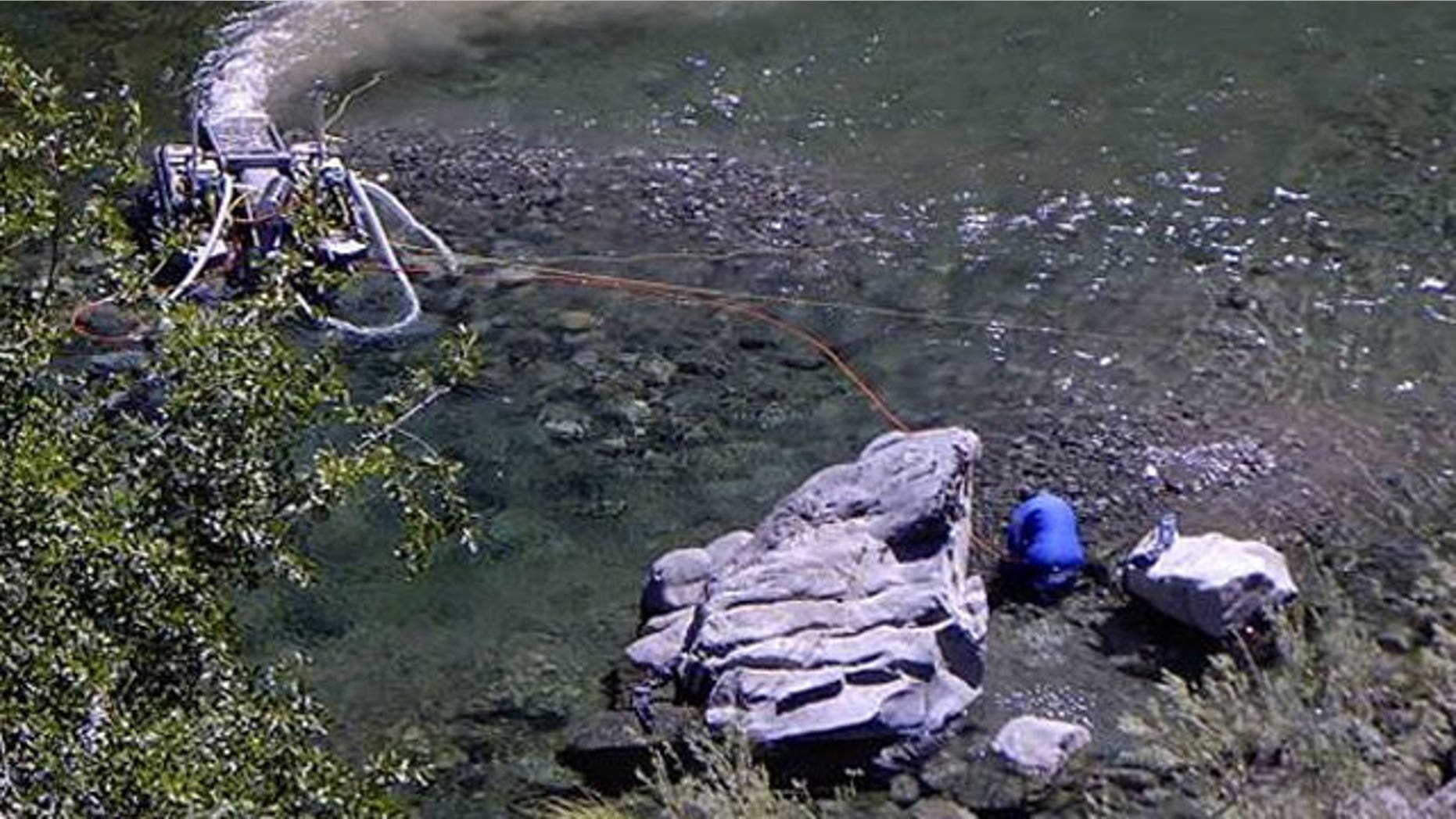 This photo provided by the Karuk tribe, shows a suction dredge.