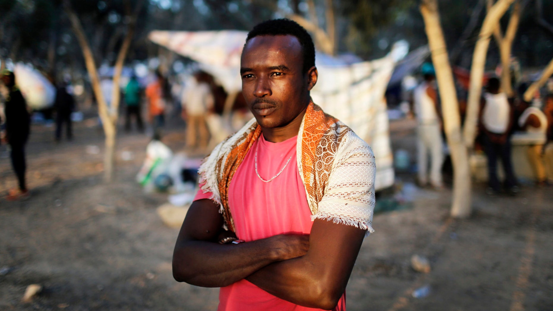 An African asylum seeker stands in the shade of trees during a protest after leaving Holot open detention centre in southern Israel's Negev desert.