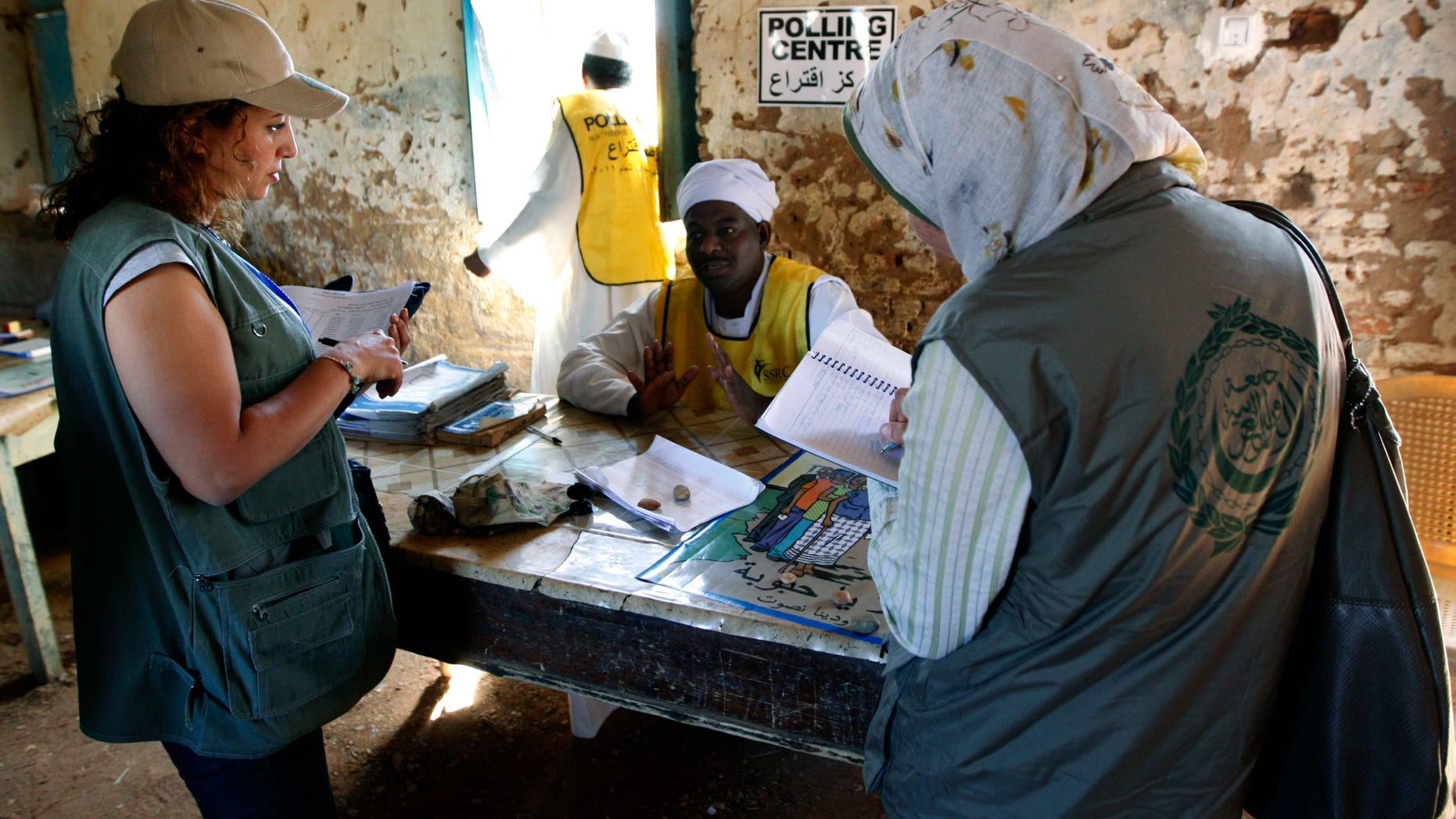 Jan. 14, 2011: Two female Arab League observers for the Southern Sudan referendum talk to a member of the polling staff at a polling center in the suburb of al-Inkaz in Khartoum, Sudan. Former U.S. President Jimmy Carter called on the international community to forgive Sudan's $39 billion debt burden so that dividing it between the north and south won't become another issue to resolve after Southern Sudan likely votes to become its own nation. (AP)