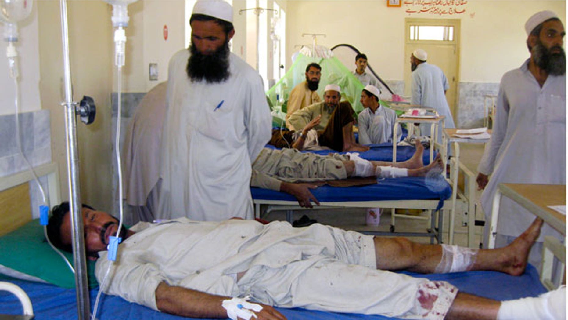Local residents gather next to their relatives injured in the bomb explosion, at a local hospital in Khar, the main town of Pakistani troubled Bajur tribal region, Saturday, May 28, 2011. A powerful bomb ripped through a restaurant at a market in a northwestern Pakistani tribal region near the Afghan border on Saturday, killing some and wounding others, officials said.