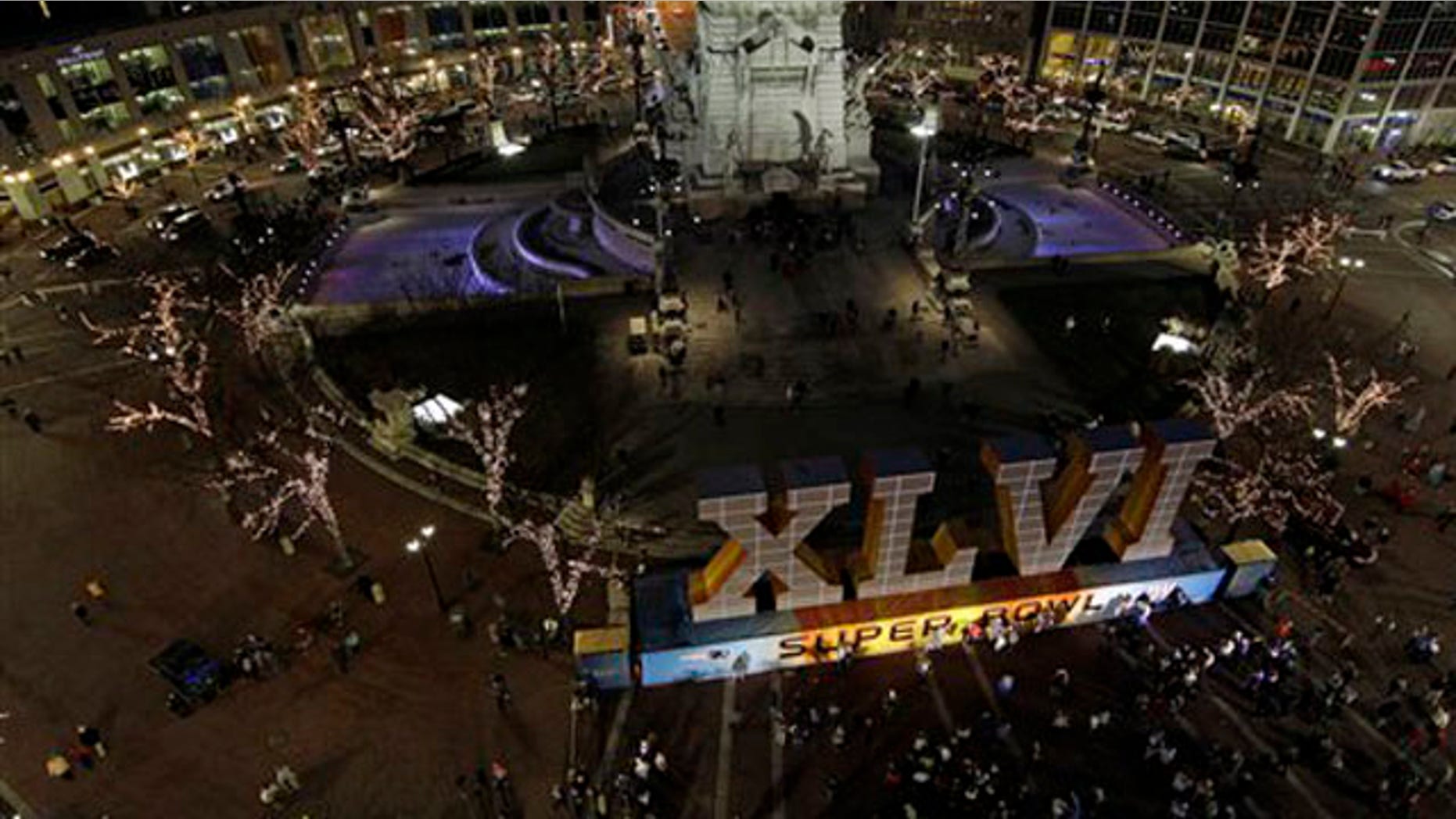 Feb. 1, 2012: Fans have their photos taken in front of the NFL Super Bowl XLVI sign on Monument Circle in Indianapolis.