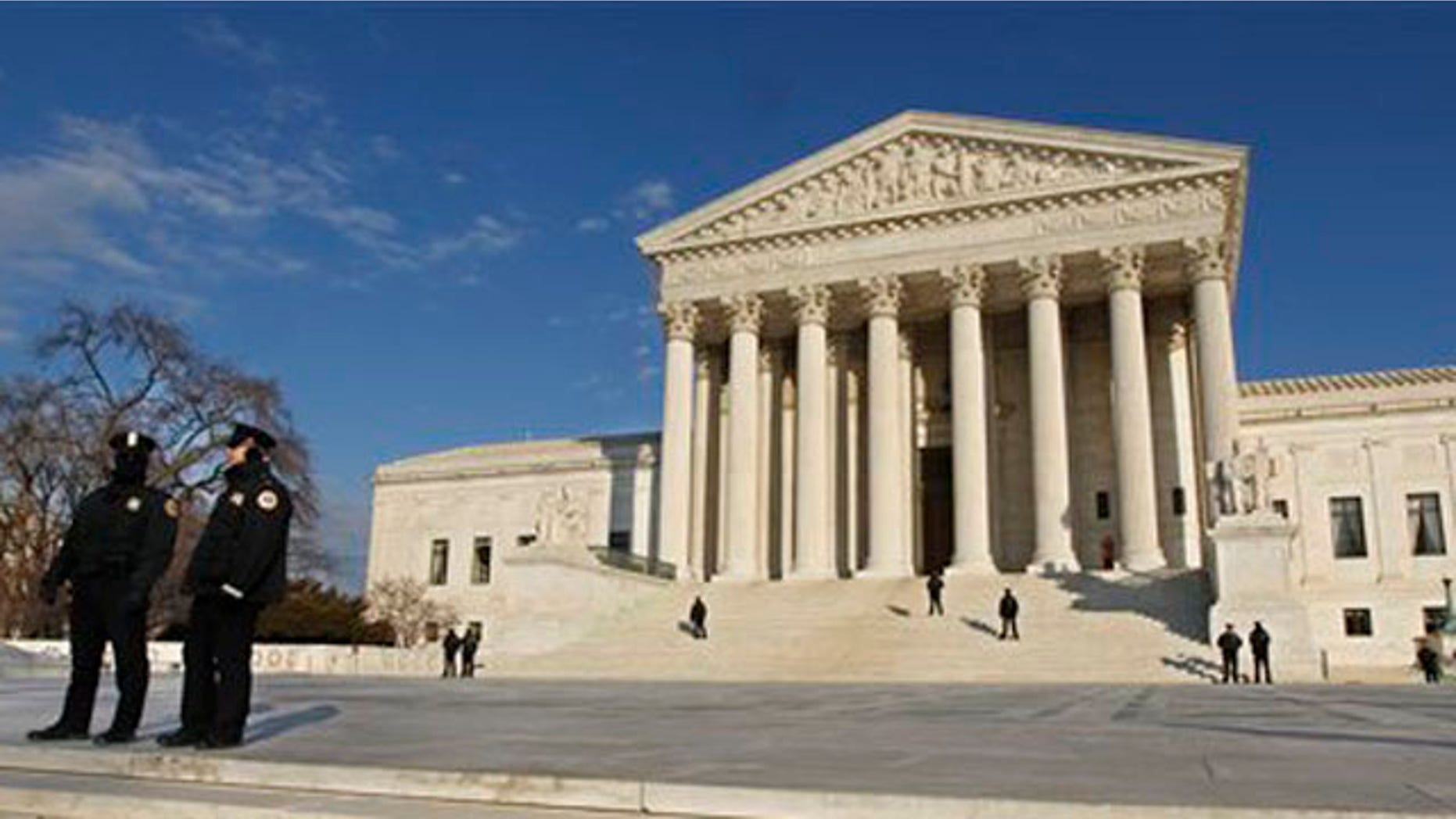 Security personnel stand guard as anti-abortion activists gather in front of the U.S. Supreme Court, in Washington, Monday, Jan. 24, 2011, during a rally against Roe v. Wade on the anniversary of the U.S. Supreme Court decision. (AP Photo/Manuel Balce Ceneta)