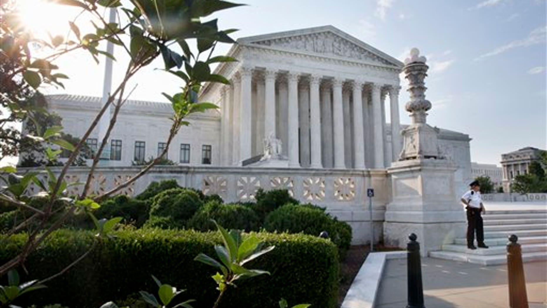 FILE -- June 25, 2015: Security guard in front of the Supreme Court in Washington. (AP Photo/Jacquelyn Martin)