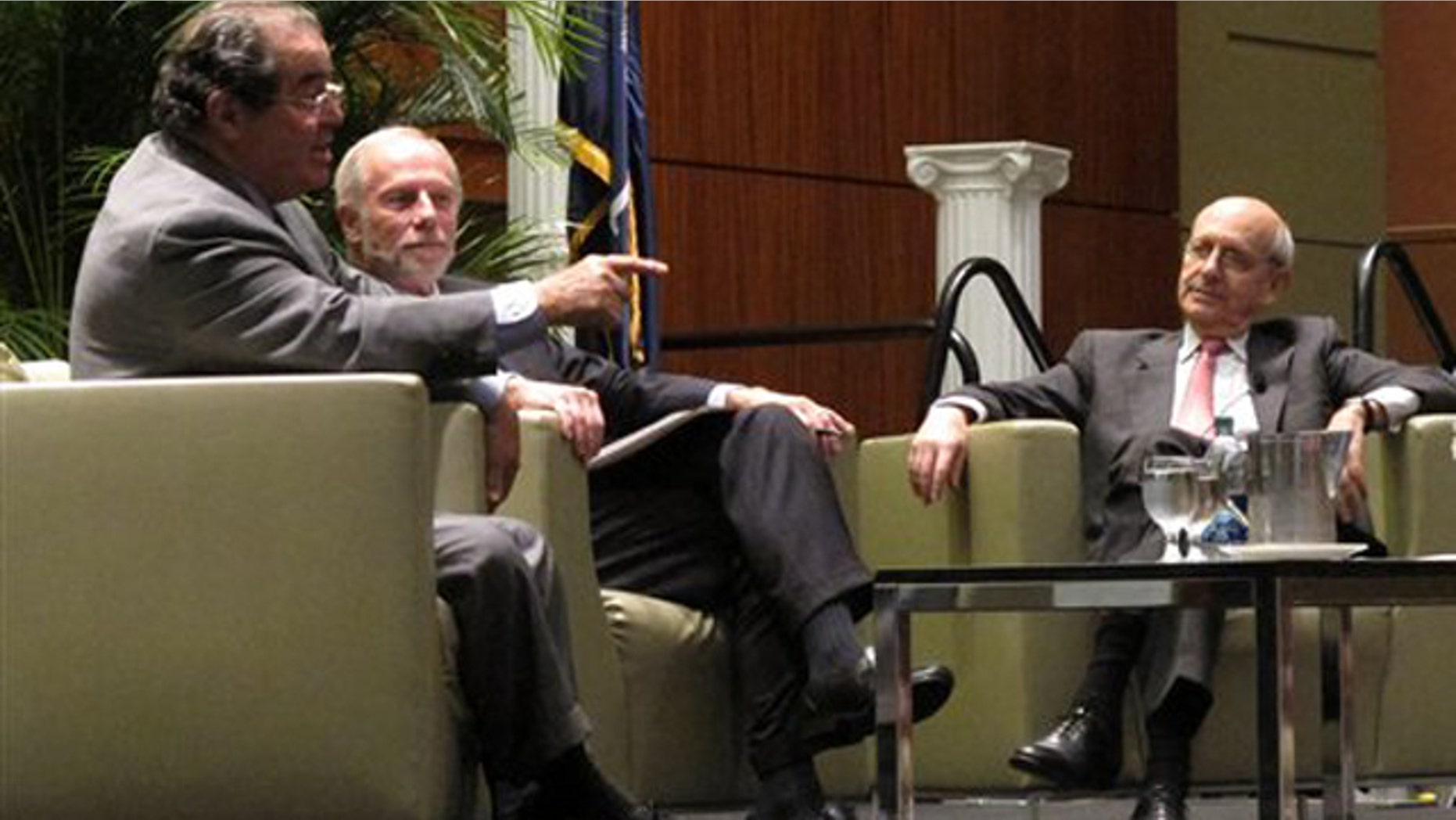Jan. 21, 2012: U.S. Supreme Court Justices Antonin Scalia, left, and Stephen Breyer, right, talk to moderator Charles Bierbauer, center, at a debate before the South Carolina Bar in Columbia, S.C.