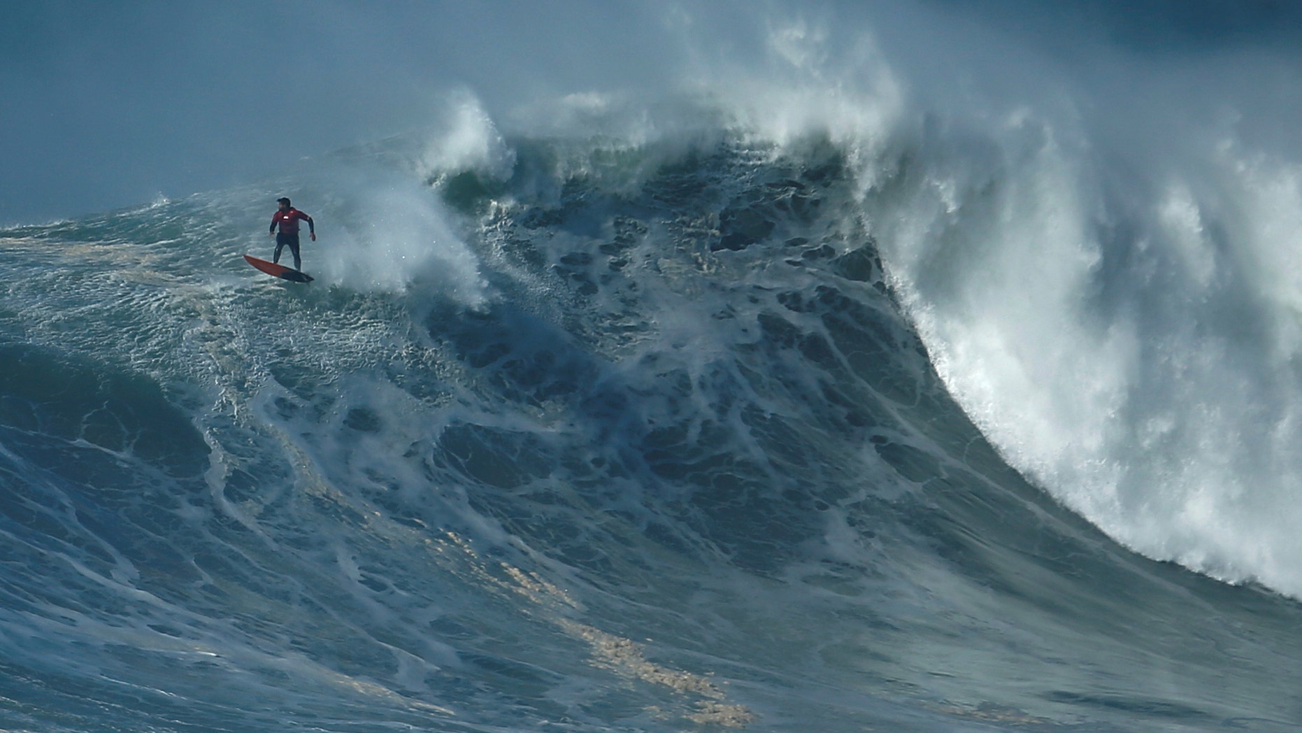 File photo: A surfer drops in on a large wave at Praia do Norte in Nazare, Portugal, February 10, 2017. (REUTERS/Rafael Marchante )