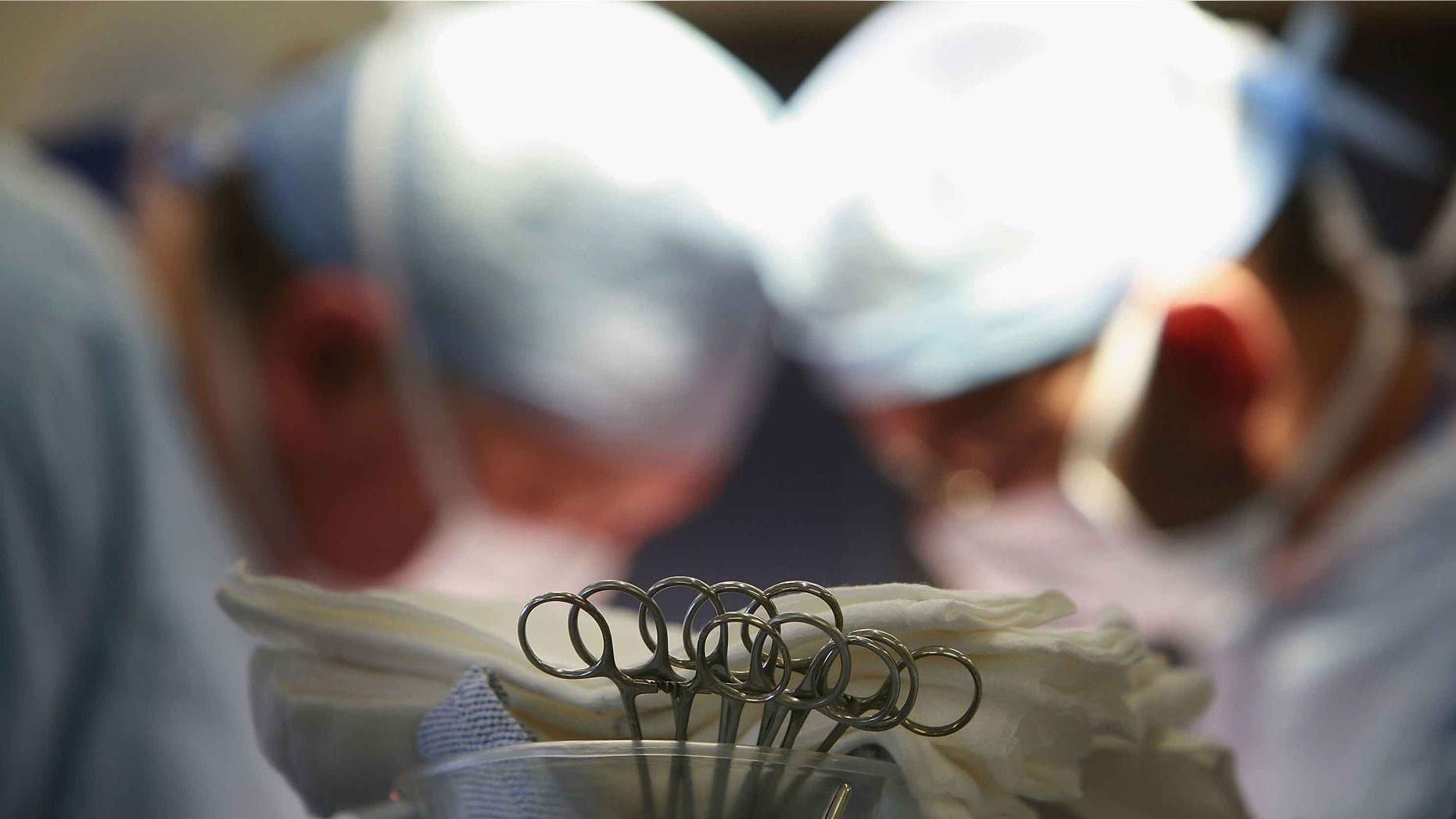 BIRMINGHAM, UNITED KINGDOM - JUNE 14: Surgeons at The Queen Elizabeth Hospital Birmingham conduct an operation on June 14, 2006, Birmingham, England. Senior managers of the NHS have said that the organisation needs to become more open in the future. (Photo by Christopher Furlong/Getty Images)