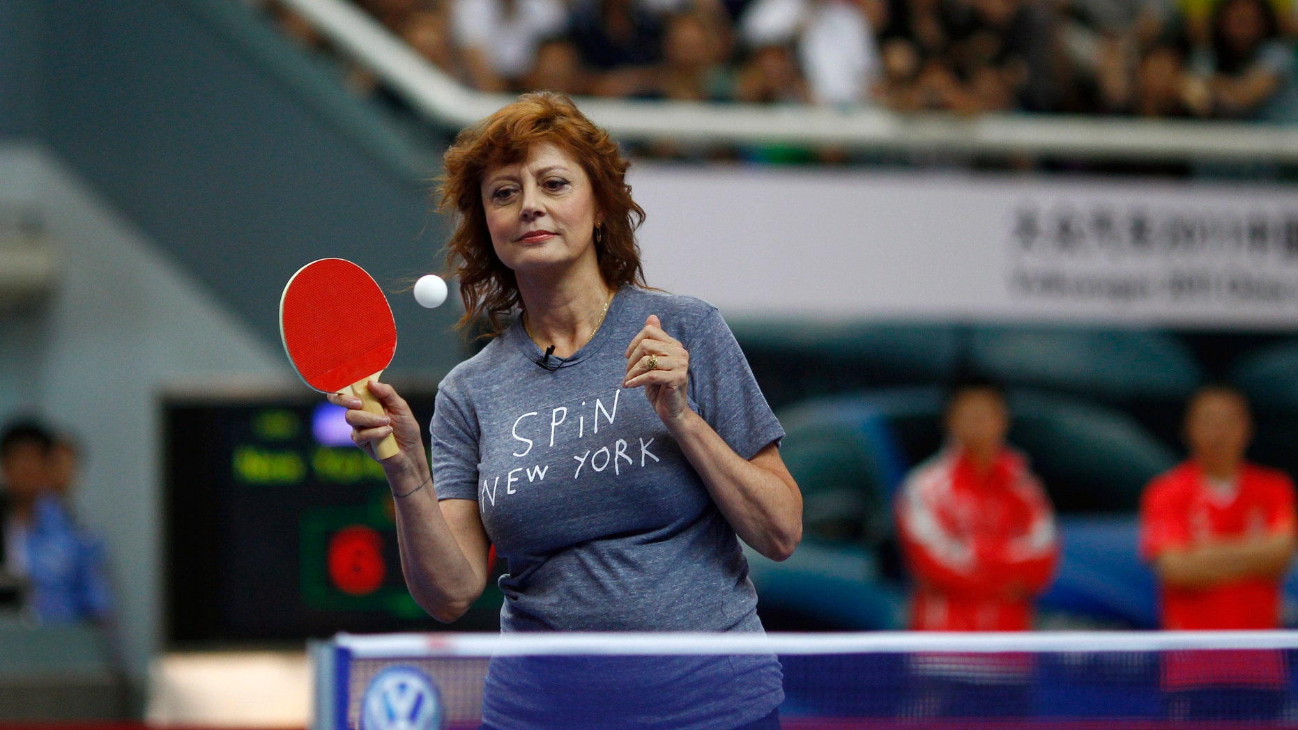 U.S. actress Susan Sarandon eyes the ball as she plays during an exhibition game at the Volkswagen 2011 China vs. World Team Challenge event in Shanghai June 25, 2011. REUTERS/Carlos Barria (CHINA - Tags: ENTERTAINMENT SPORT TABLE TENNIS) - RTR2O2Q9
