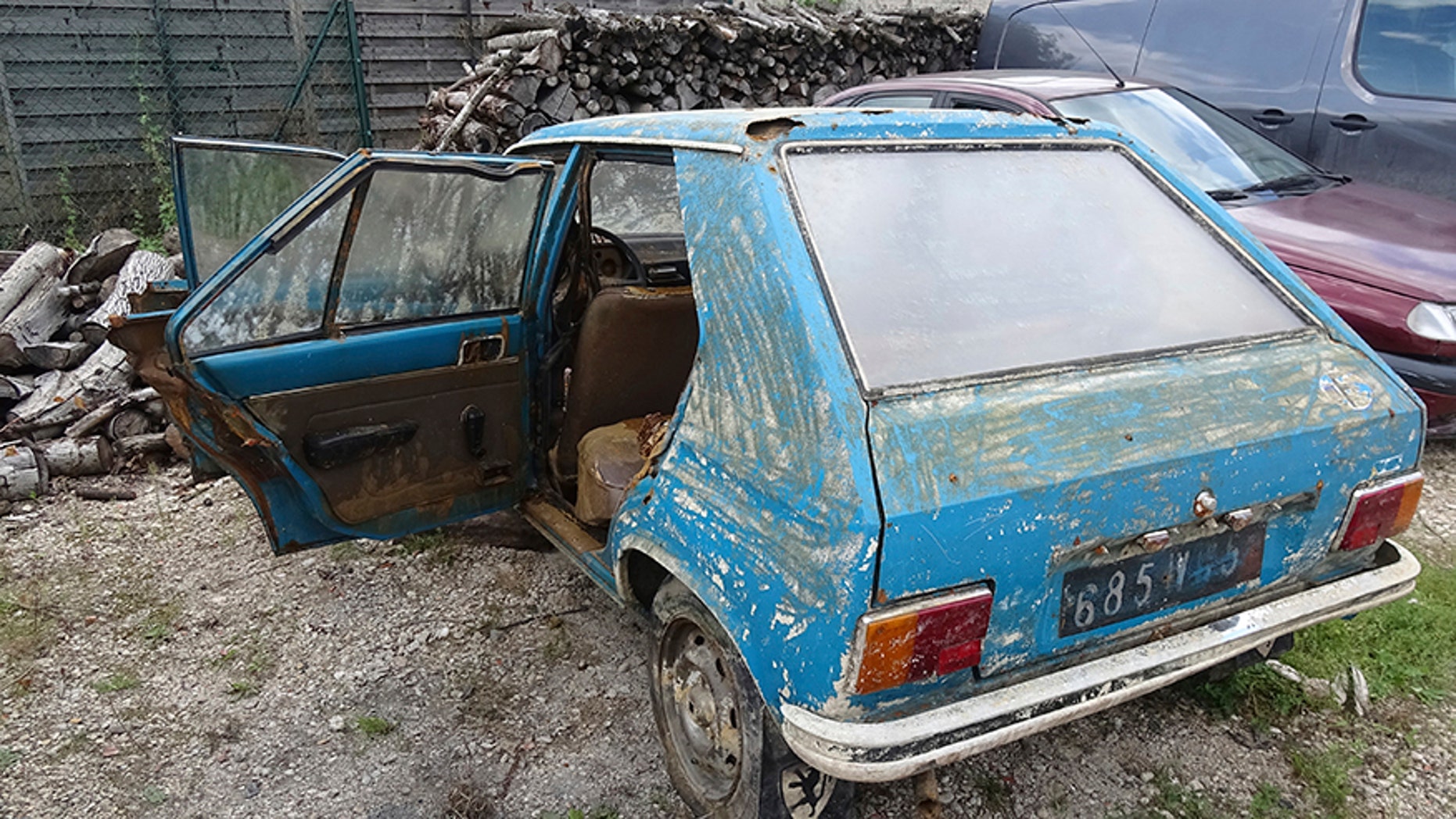 A Peugeot 104, which was recovered this week 38 years after it was stolen, is stored in a garage in Chalons-en-Champagne, eastern France, Friday, Sept. 1, 2017. A blue Peugeot 104 stolen in the heart of France's Champagne country in 1979 is being reunited with its owner - 38 years later - after French police pulled it, in surprisingly good shape but teeming with crayfish, from a murky swamp. (AP Photo/Chris den Hond)