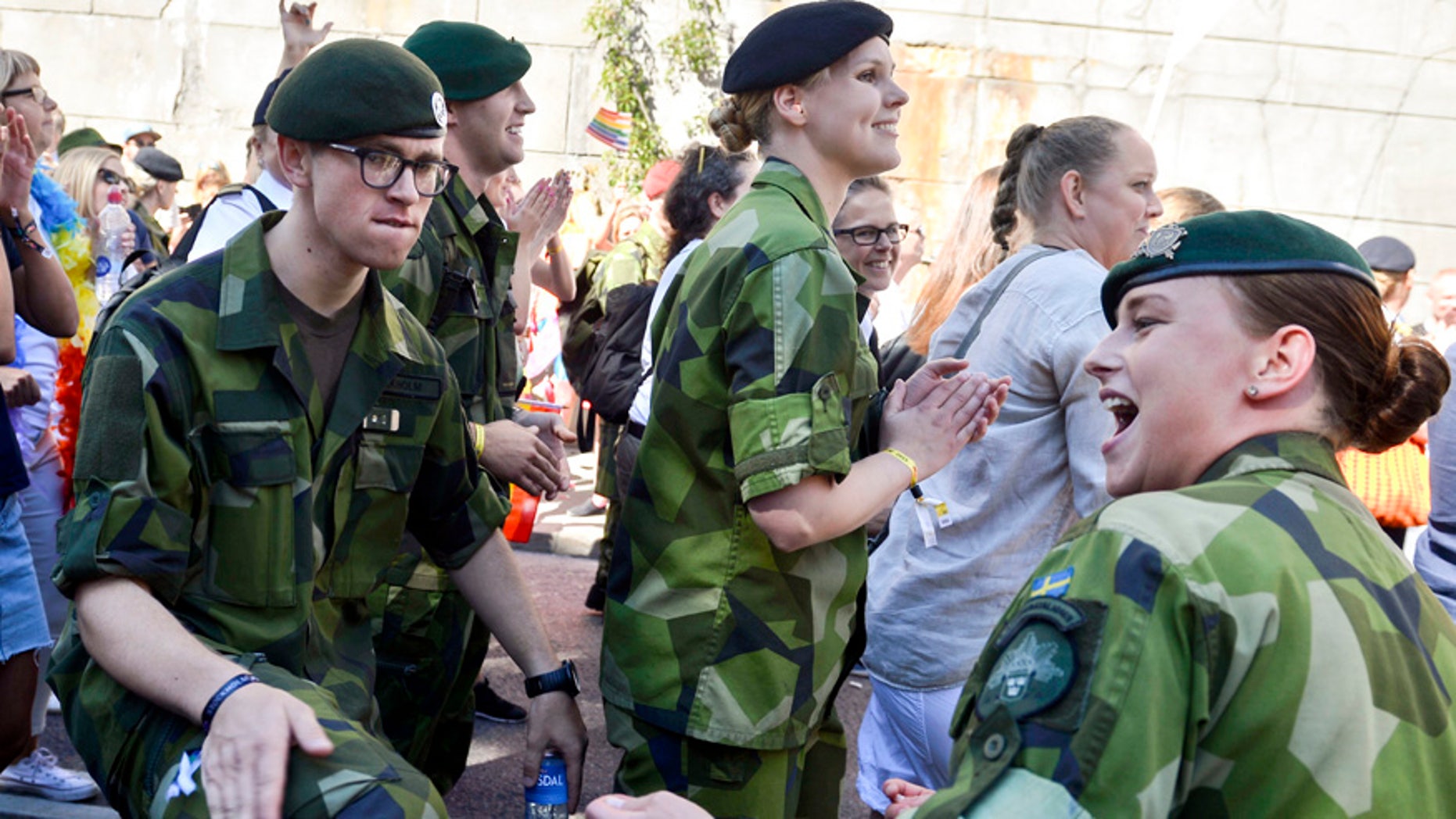 FILE - This is a Saturday Aug. 1, 2015 file photo of Swedish Army personnel as they take part in the annual gay Pride Parade in Stockholm. Sweden's left-leaning government is reintroducing a military draft for both men and women because of what Defense Minister Peter Hultqvist calls a deteriorating security environment in Europe and around Sweden. T ?(Vilhelm Stokstad/TT , File via AP)