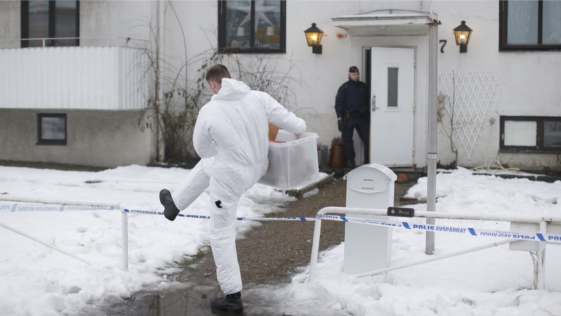 Jan. 25, 2016: A forensic police officer carries a box of evidence following a search in front of a refugee center in Molndal outside Gothenburg, Sweden.
