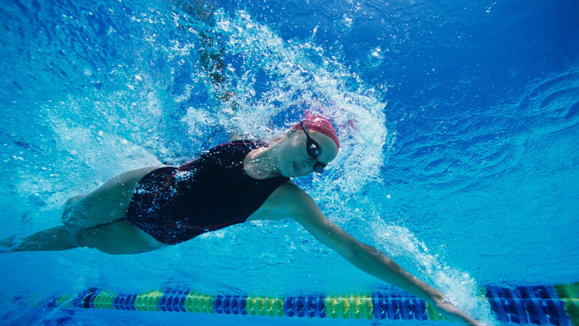 Female Swimmer Swimming Mid-stroke