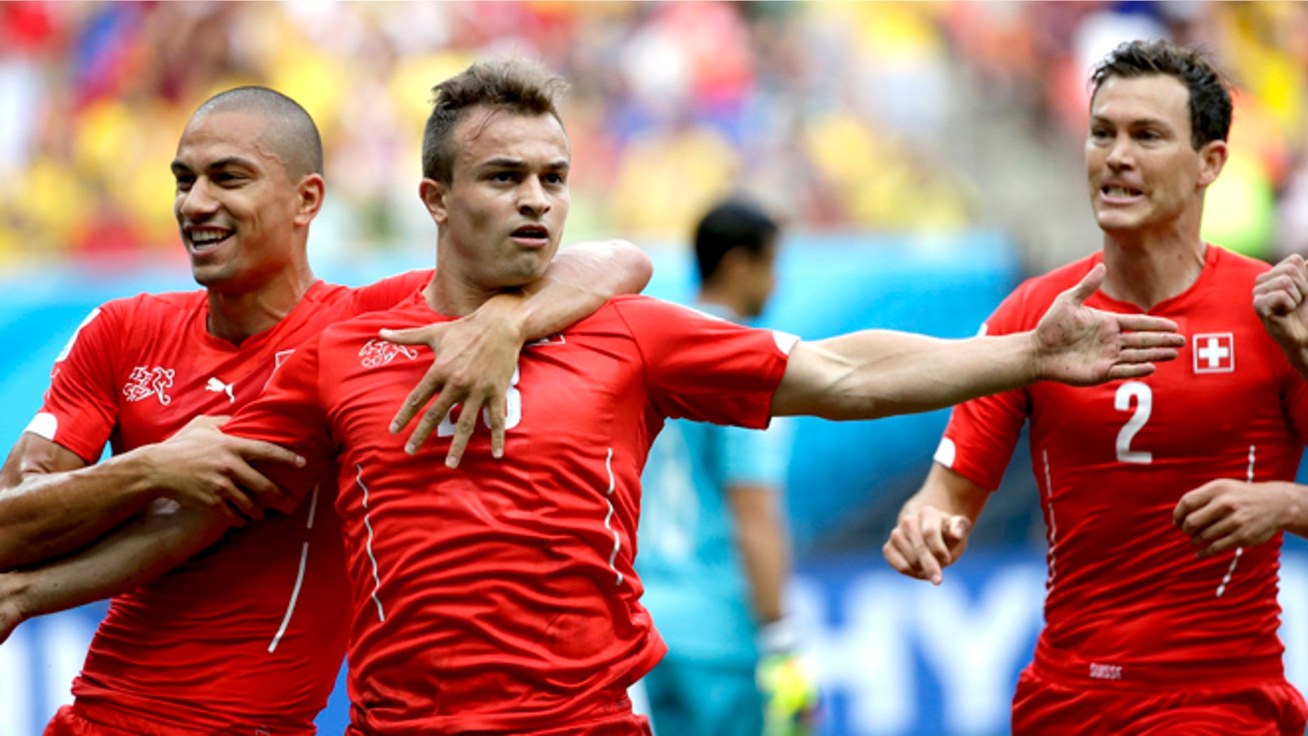 June 25, 2014: Switzerland's Xherdan Shaqiri, center, celebrates with teammate Goekhan Inler, left, and Stephan Lichtsteiner (2) after scoring during the group E World Cup soccer match between Honduras and Switzerland at the Arena da Amazonia in Manaus, Brazil.