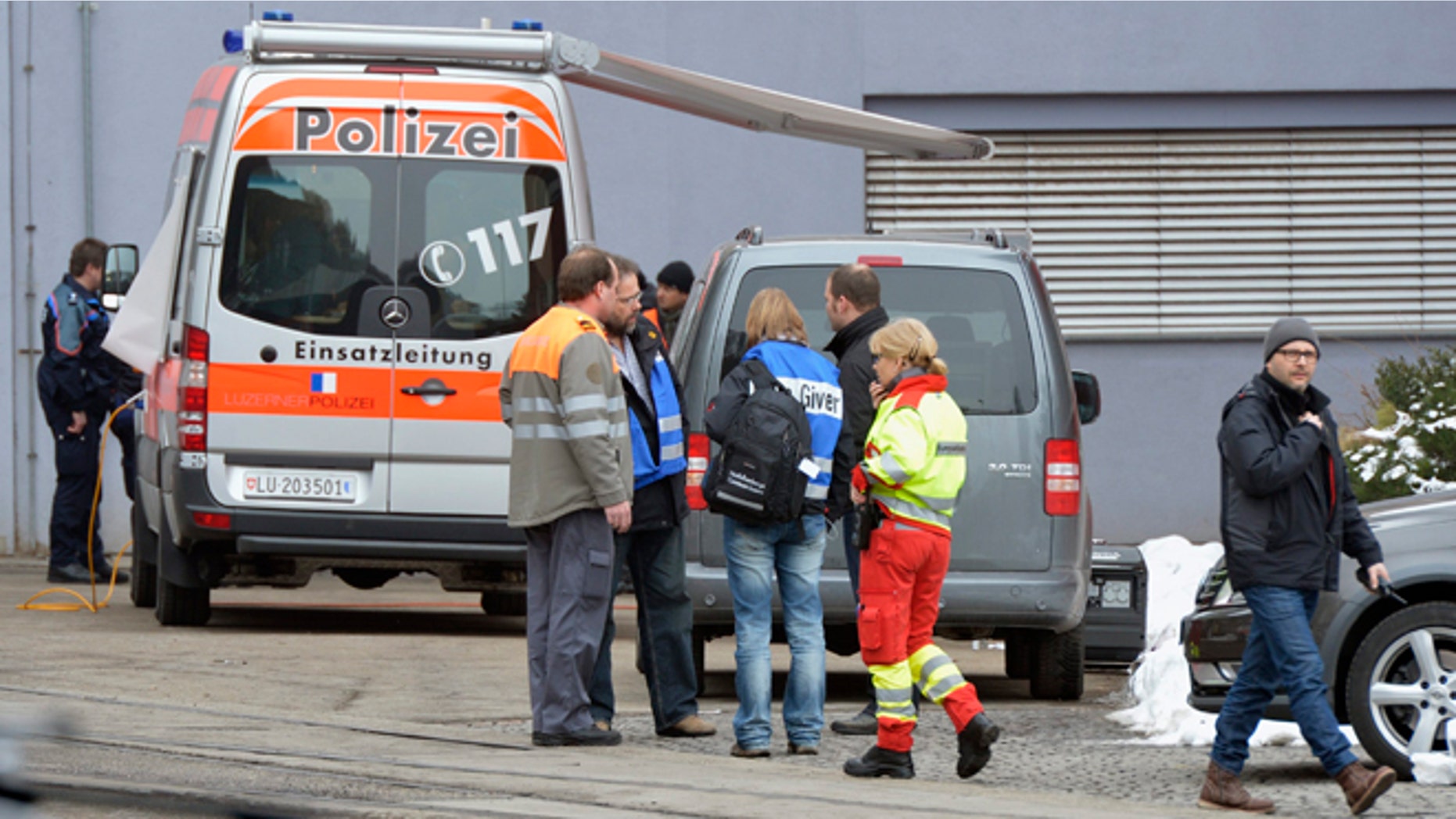 Feb. 27, 2013: Police stand in front of a wood-processing company in Menznau, central Switzerland, where several people were killed in a shooting. Police in Lucerne canton (state) said in a statement that the shooting occurred shortly after 9 a.m. at the premises of Kronospan, a company in the small town west of Lucerne. They said there were several dead and several seriously injured people and that rescue services were deployed and the scene sealed off.