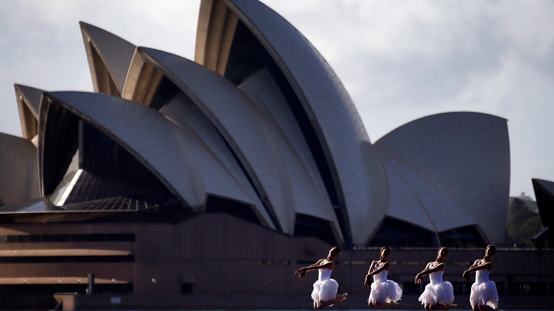 File photo - Ballerinas from The Australian Ballet perform on a floating platform, during a promotional event in front of the Sydney Opera House, February 18, 2015. The event was to promote the Australian Ballet's upcoming performance of Swan Lake opening on Feb. 20. (REUTERS/David Gray)