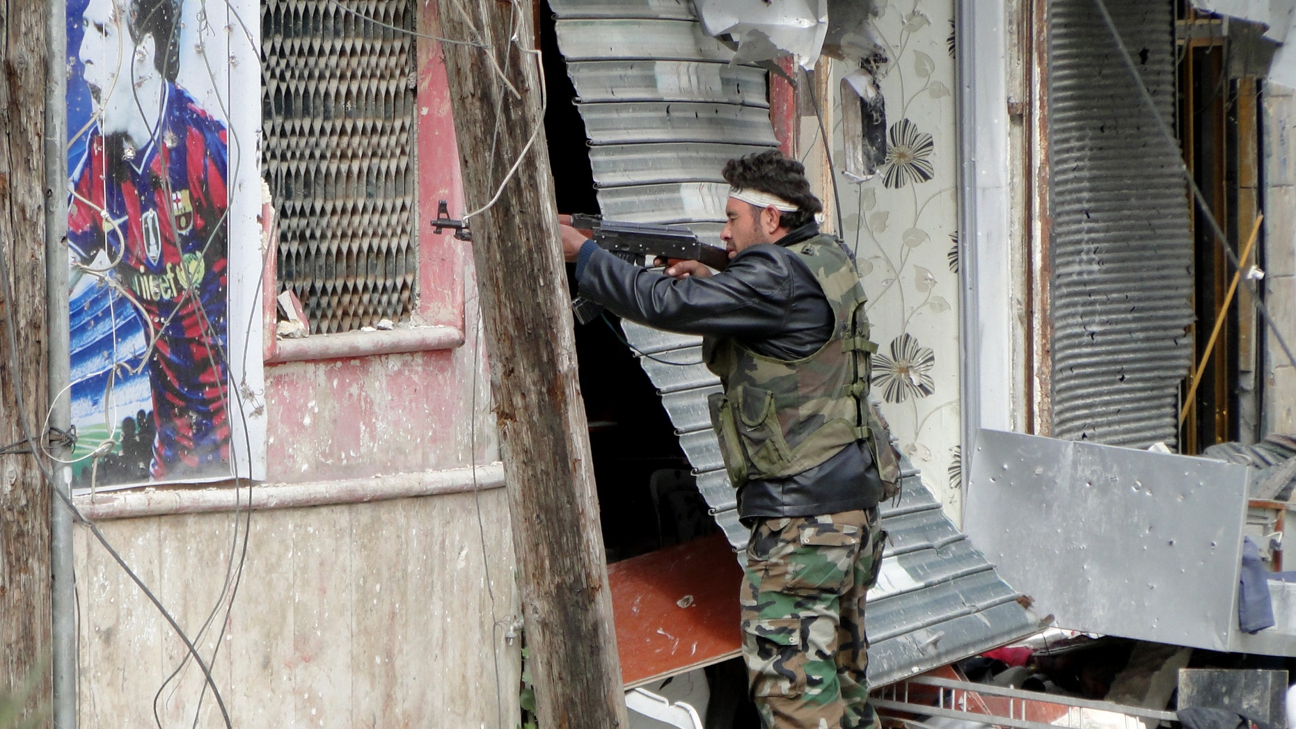 March 28, 2013 - Free Syrian Army fighters take position in Aleppo's Salaheddine district.