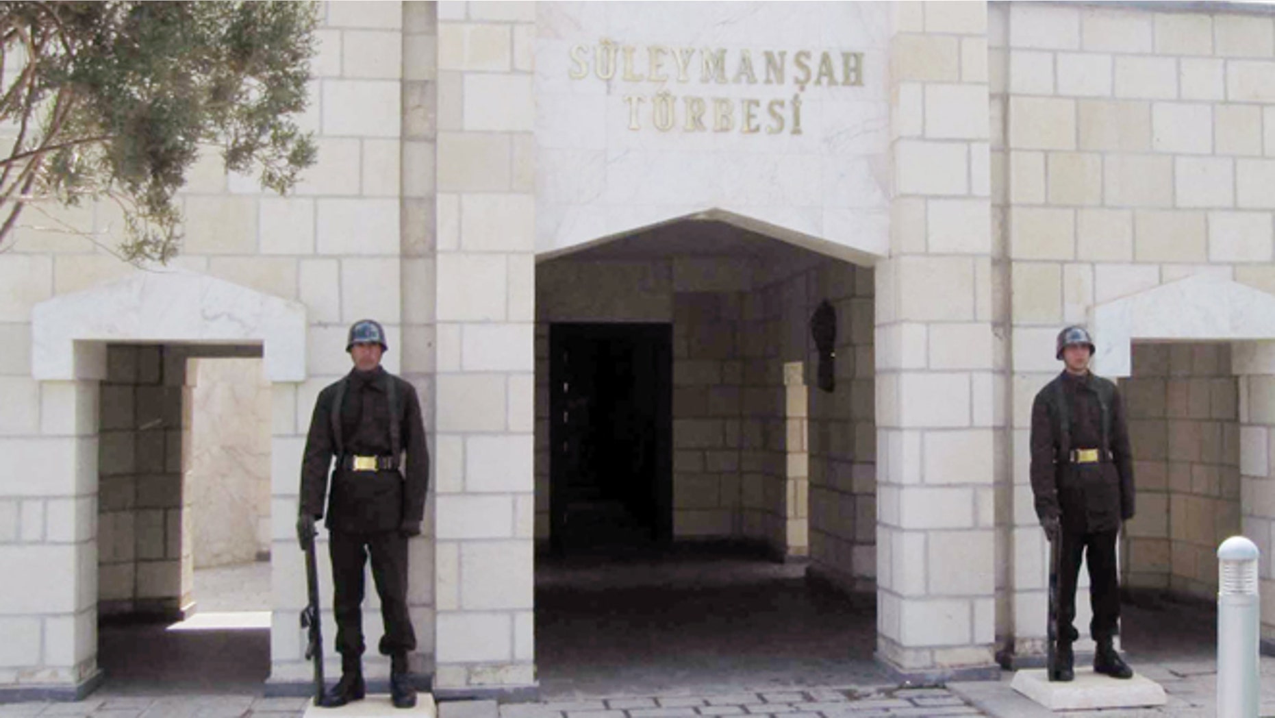 In this April 7, 2011 file photo, Turkish soldiers stand guard at the entrance of the memorial site of Suleyman Shah, grandfather of Osman I, founder of the Ottoman Empire, in Karakozak village, northeast of Aleppo, Syria.