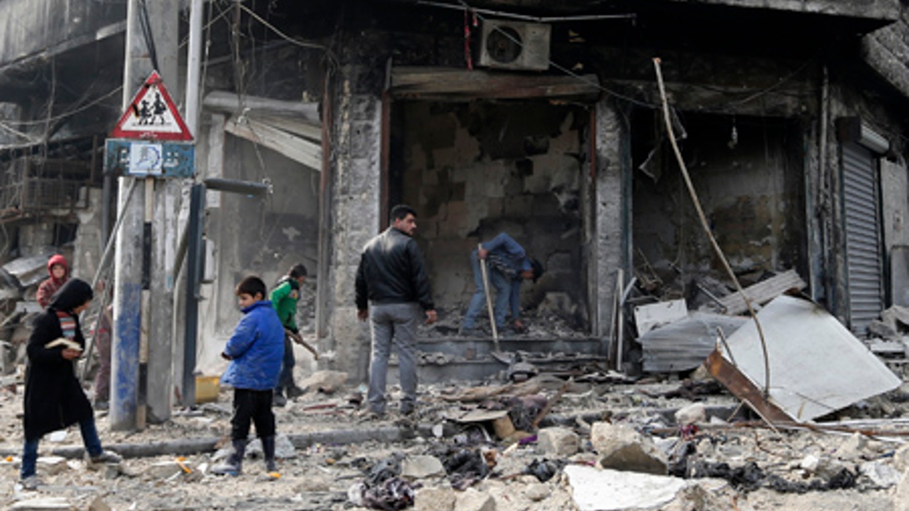 Syrian children remove rubble in the once rebel-held Bustan al-Qasr neighborhood in eastern Aleppo, Syria.