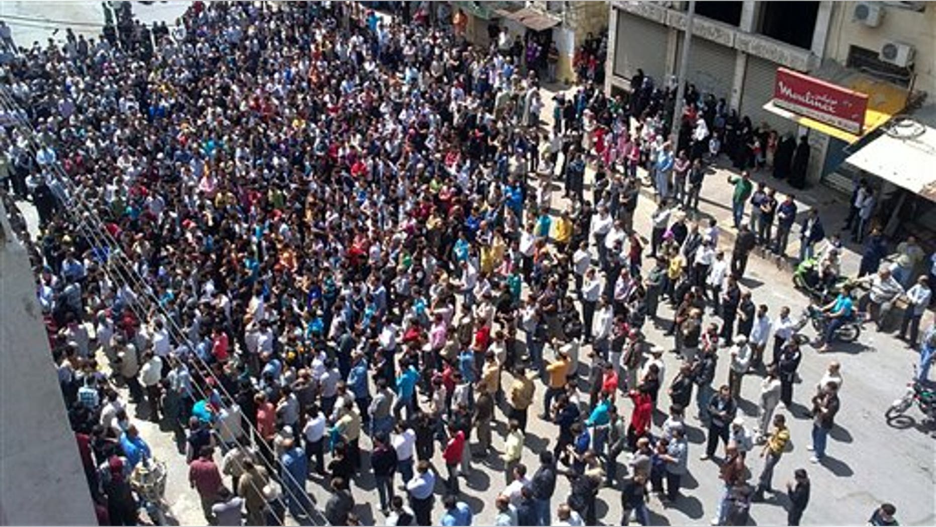 In this citizen journalism image made on a mobile phone and acquired by the AP, Syrian anti-government protesters gather in the coastal town of Banias, Syria, Friday, May 6, 2011. Syrian security forces opened fire on protesters Friday, killing at least 16 people as thousands joined demonstrations across the country calling for an end to President Bashar Assad's regime, witnesses and activists said. (AP)