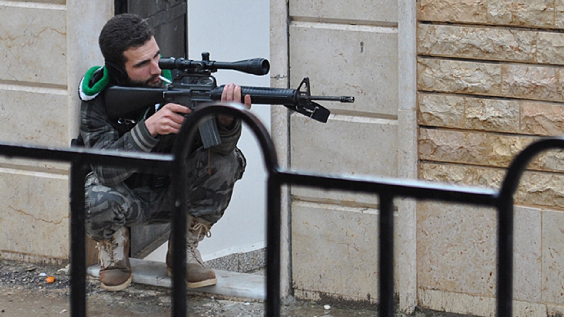 Jan. 31: A Syrian rebel takes his position as he points his gun during a battle with the Syrian government forces, at Rastan area in Homs province, central Syria.