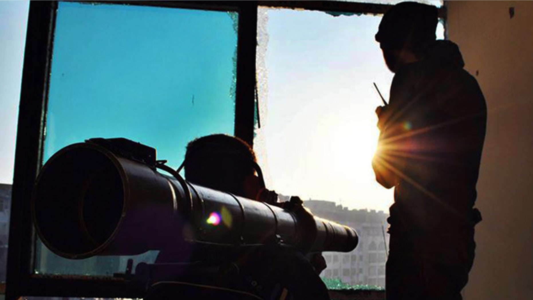 June 18, 2013: This citizen journalism image provided by Lens Young Homsi, which has been authenticated based on its contents and other AP reporting, shows Syrian rebels using a rocket launcher to attack Syrian soldiers loyal to Syrian president Bashar Assad, in Homs province, Syria. Syrian warplanes bombed rebel positions near a contested military air base in the north of Syria on Tuesday, activists said, while President Bashar Assad's forces nearby pressed ahead with an offensive against opposition fighters in the country's largest city Aleppo.