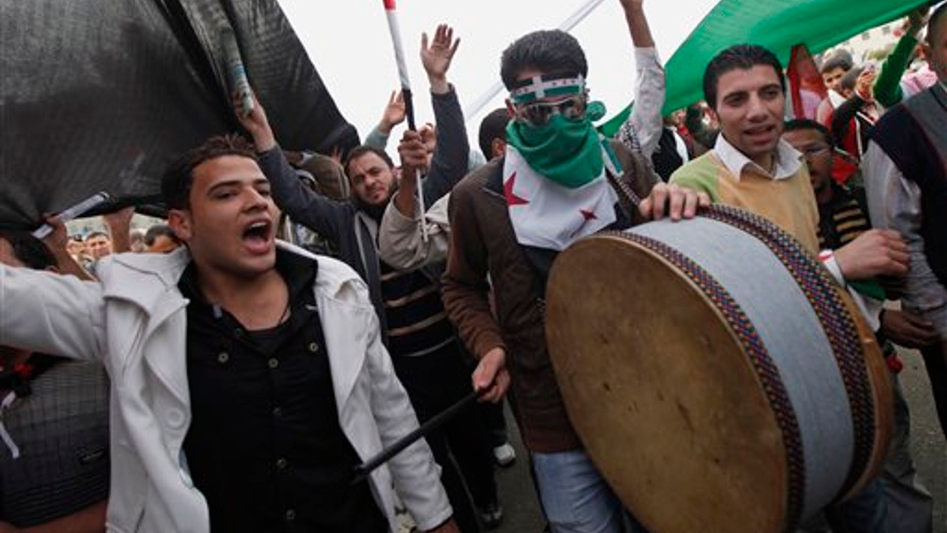 Nov. 18, 2011: Protesters chant anti-Syrian regime slogans in Tahrir Square, the focal point of the uprising that ousted President Hosni Mubarak, in Cairo, Egypt, Friday, Nov. 18, 2011. Thousands of Egyptians are rallying in Cairo's Tahrir square, with Islamists in the forefront, in a protest against what they say are attempts by the country's military rulers to reinforce their powers.