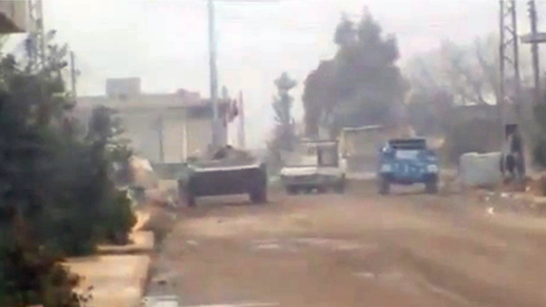 Dec. 21, 2011: In this image from amateur video made available by the Ugarit News group purports to show military vehicles in Homs, Syria.