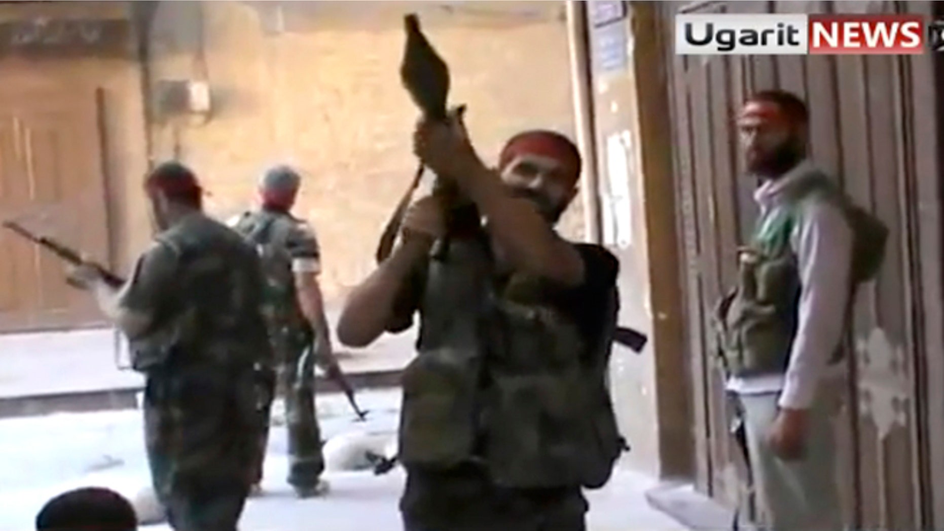 Sept. 28, 2012: In this image taken from video obtained from Ugarit news, which has been authenticated based on its contents and other AP reporting, Syrian rebels gather as they engage government forces in Aleppo, Syria.