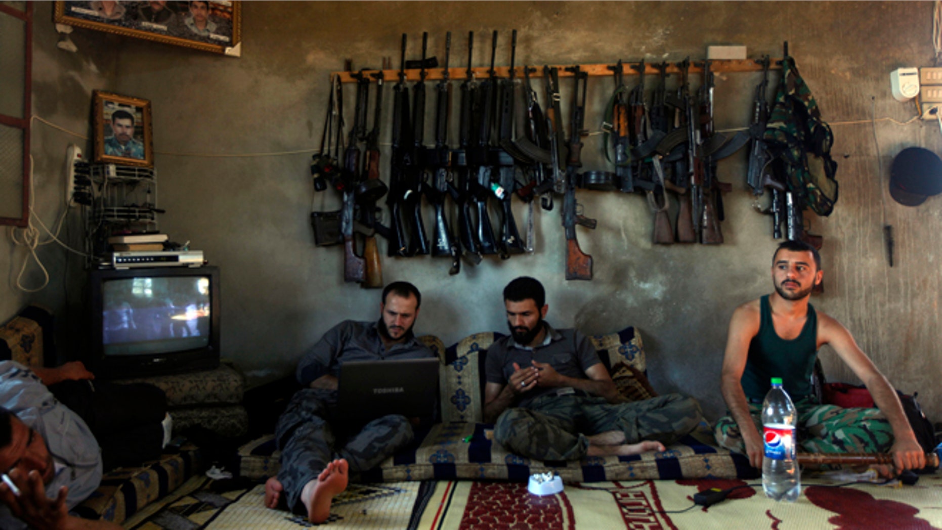 June 12, 2012: Free Syrian Army fighters sit in a house on the outskirts of Aleppo, Syria.