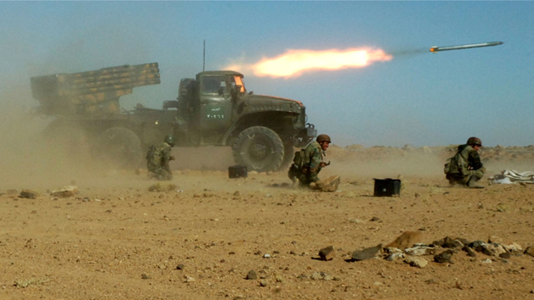 This Sunday, Dec. 4, 2011 photo provided by the Syrian official news agency SANA, shows Syrian soldiers kneeling next to a multiple rocket launcher as they fire missiles during a maneuver at an unknown location, in Syria. As the Obama administration tries to prod Congress into backing armed action against Syria, the regime in Damascus is hiding military hardware and shifting troops out of bases into civilian areas.