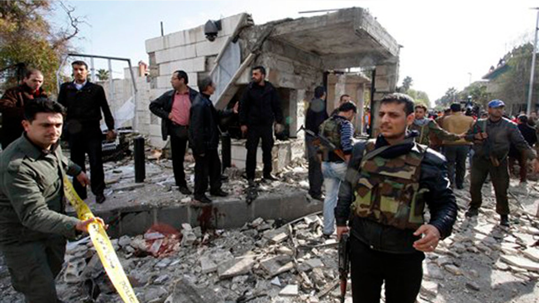 Dec. 23, 2011: Members of Syrian security are seen at the site of a suicide bombing in Damascus, Syria.