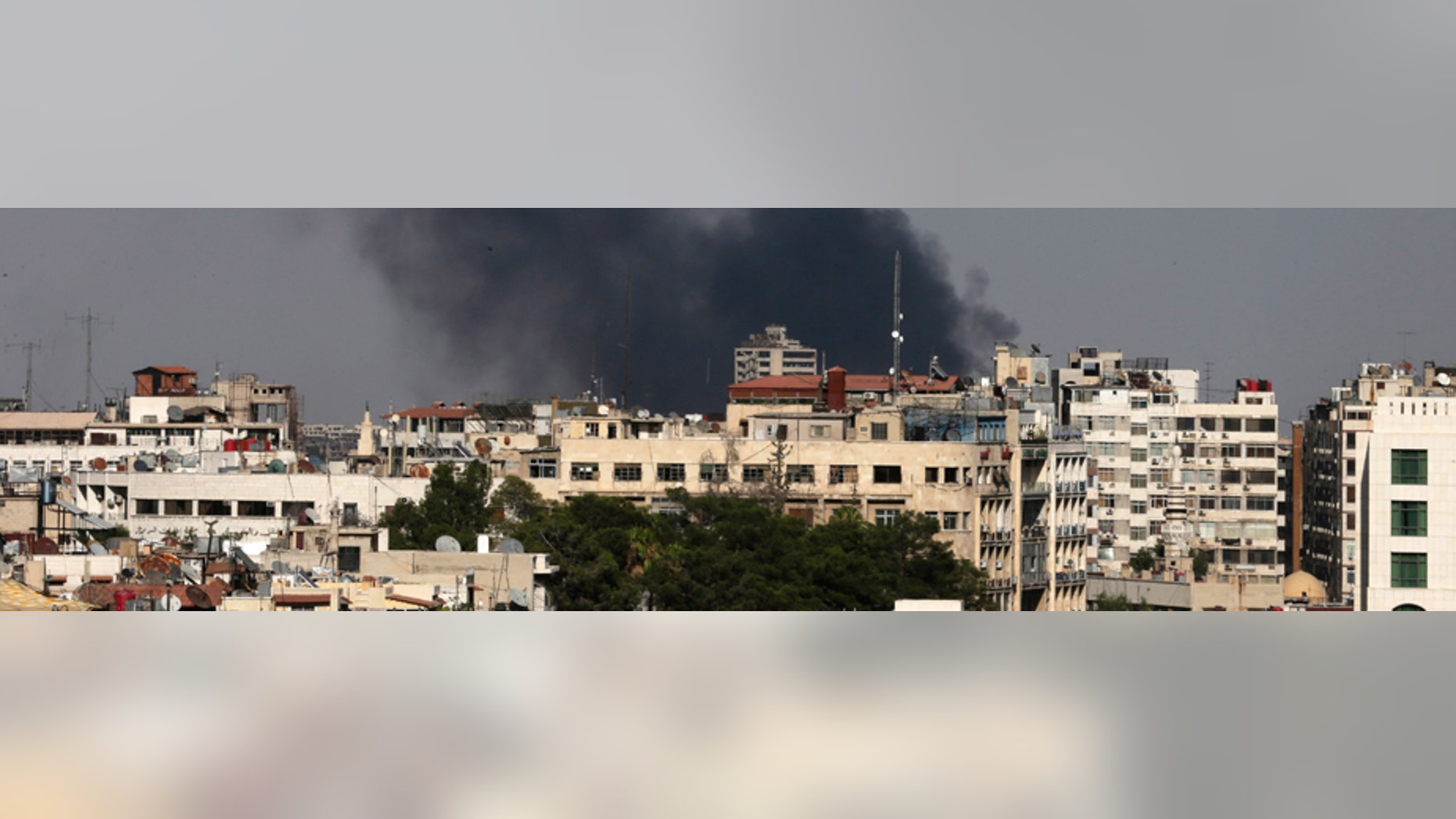 Black columns of smoke rise from heavy shelling in the Jobar neighborhood, east of Damascus, Syria, Sunday, Aug. 25, 2013. Syria reached an agreement with the United Nations on Sunday to allow a U.N. team of experts to visit the site of alleged chemical weapons attacks last week outside Damascus, state media said. (AP Photo/Hassan Ammar)