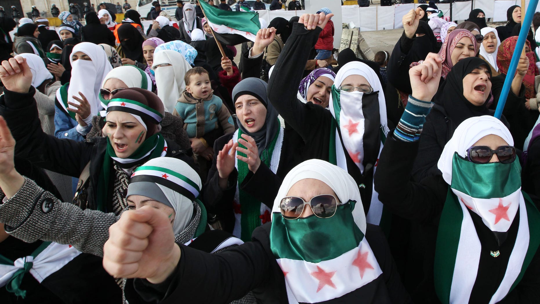Dec. 9, 2011: Syrians living in Jordan shout slogans during a demonstration against Syrian President Bashar al-Assad after Friday prayers in front of the Syrian Embassy in Amman.
