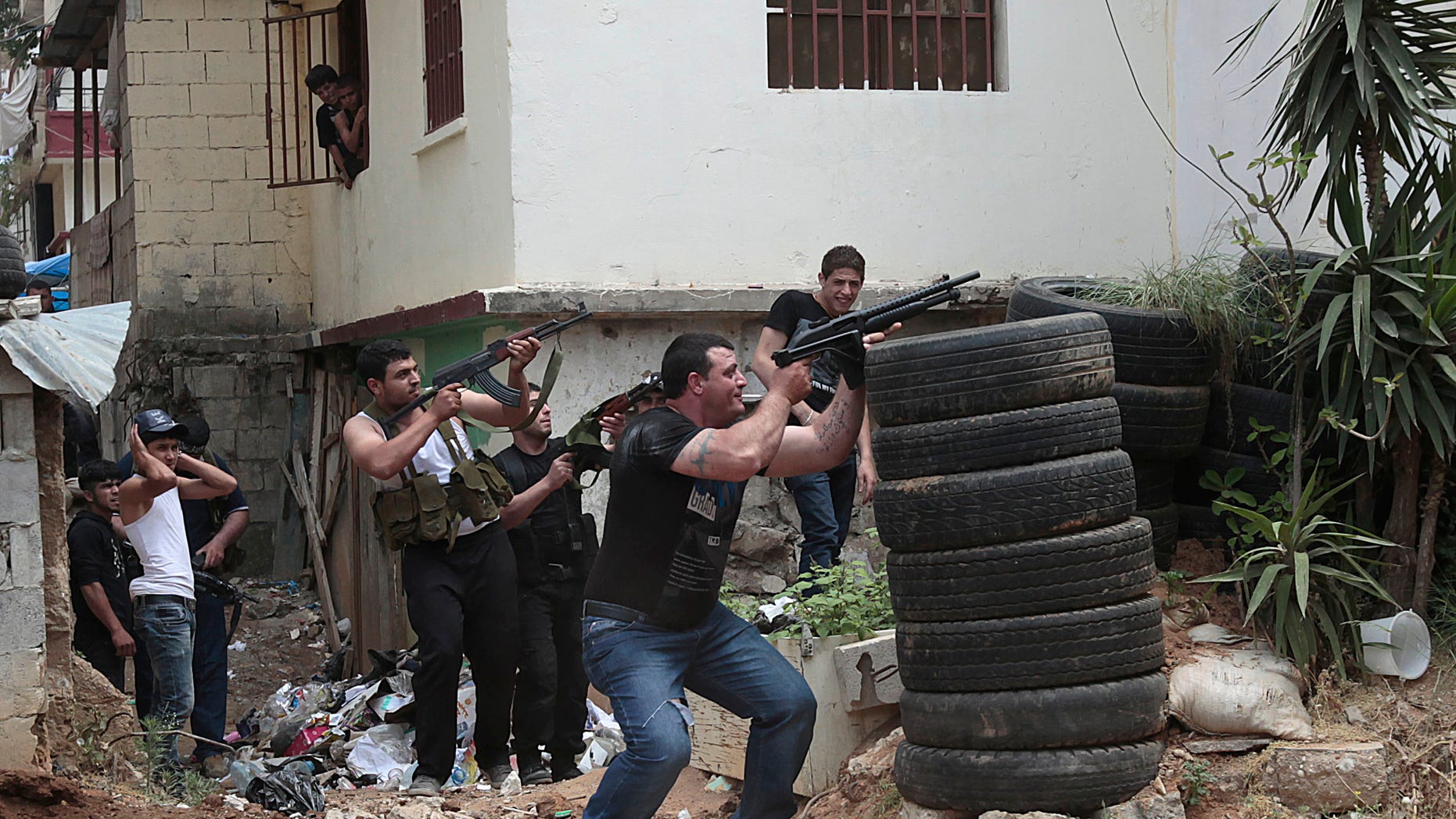 May 13, 2012: Sunni gunmen fire during clashes, in the northern port city of Tripoli, Lebanon, Sunday May 13, 2012. Gunfire broke out in the city Saturday and continued through the night primarily between a neighborhood populated by Sunni Muslims who hate Syrian President Bashar Assad and another area with many Assad backers from his Alawite sect.