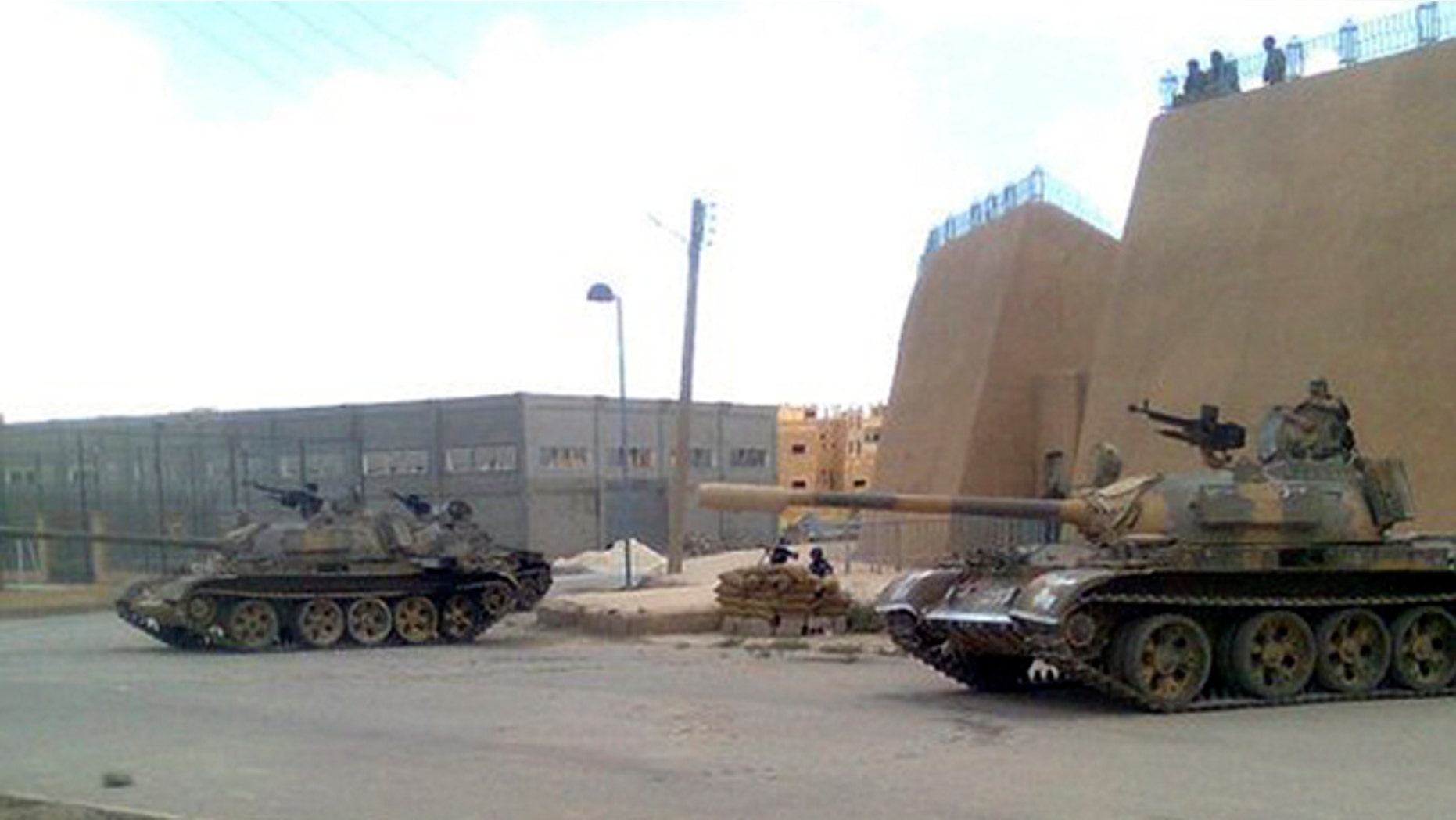 June 14: In this citizen journalism image made on a mobile phone and provided by Shaam News Network and with information according to them, showing a Syrian army tank deployed in the Syrian eastern province of Deir el-Zour, Syria.