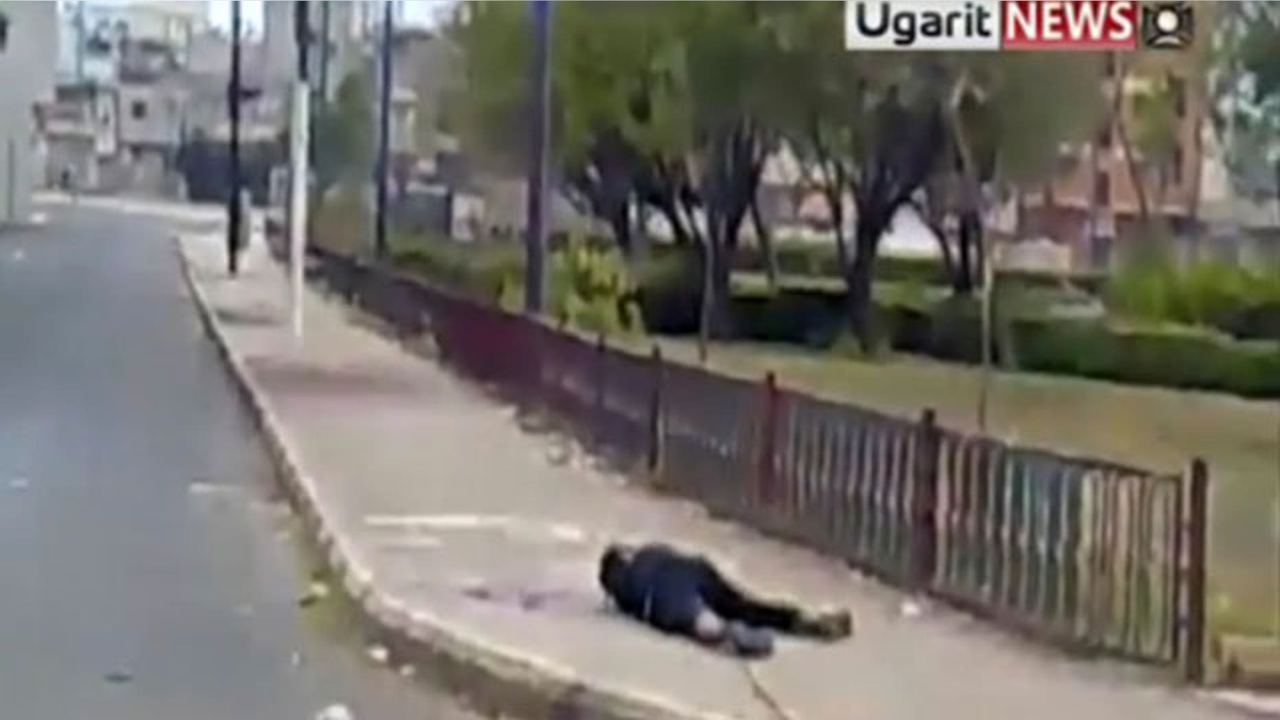 Dec. 9, 2011: Amateur video shows a dead body being dragged by a metal rod in Homs, Syria.