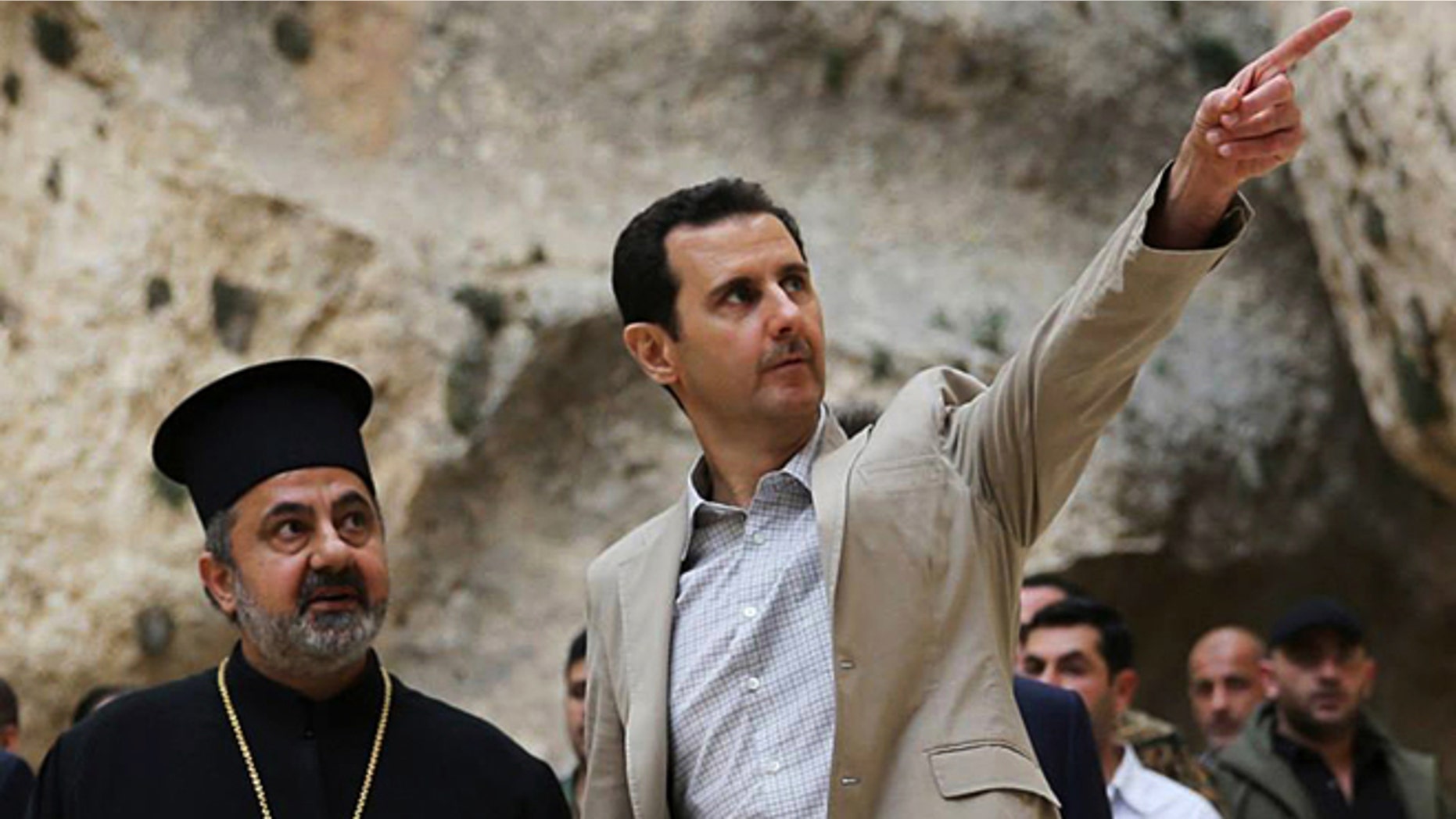 April 20, 2014: In this file photo, released by the Syrian official news agency SANA, Syrian President Bashar Assad, right, visits the Christian village of Maaloula, near Damascus, Syria.