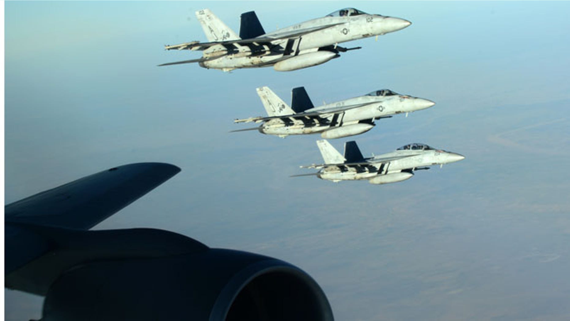 Sept. 23, 2014: In this photo released by the U.S. Air Force, a formation of U.S. Navy F-18E Super Hornets leaves after receiving fuel from a KC-135 Stratotanker over northern Iraq as part of U.S. led coalition airstrikes on the Islamic State group and other targets in Syria. (AP)