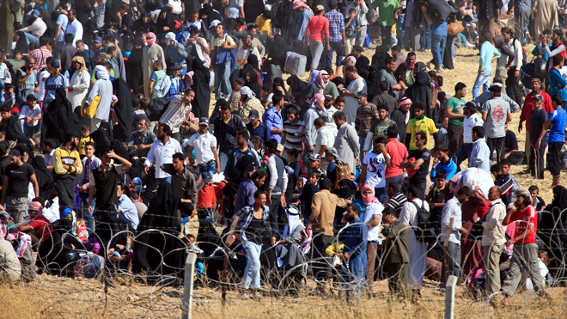 June 13, 2015: In this photo taken from the Turkish side of the border between Turkey and Syria, in Akcakale, Sanliurfa province, southeastern Turkey, (AP)