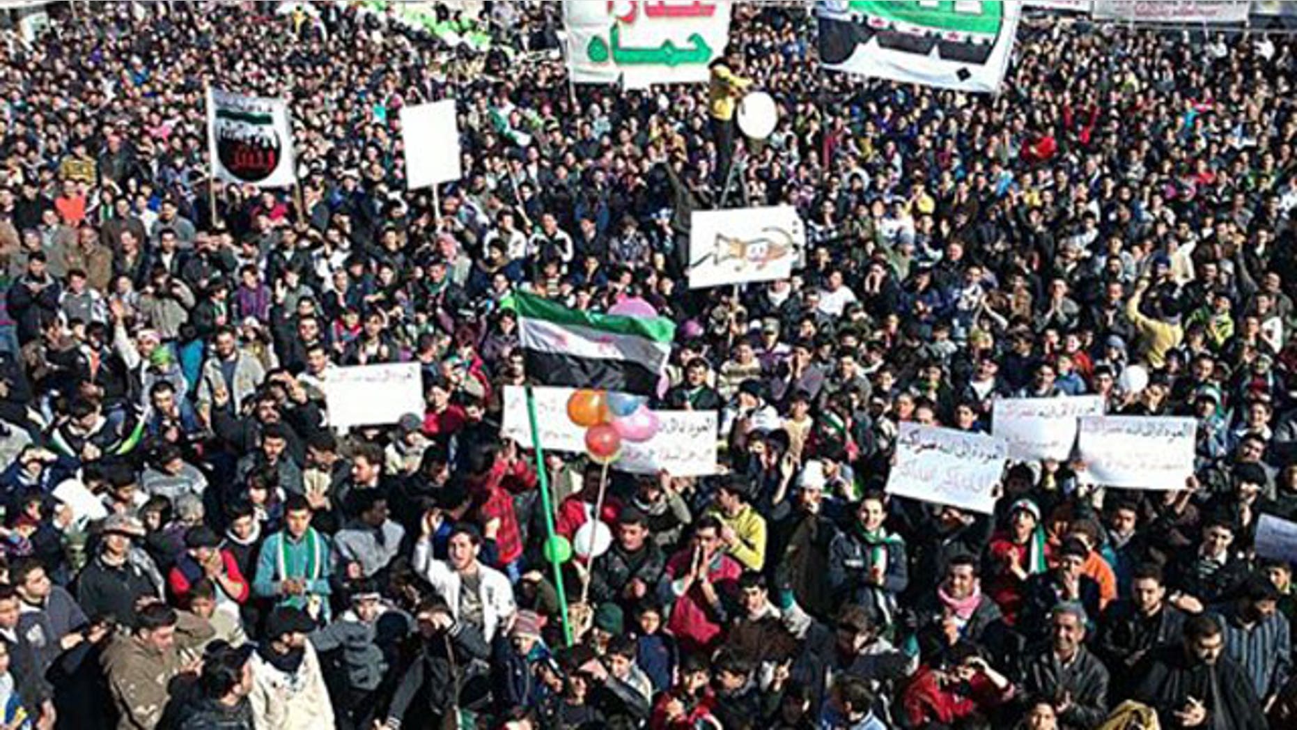 In this citizen journalism image provided by the Local Coordination Committees in Syria and released Friday, Feb. 3, 2012, anti-Syrian regime protesters march in Bensh, Idlib Province, northern Syria.