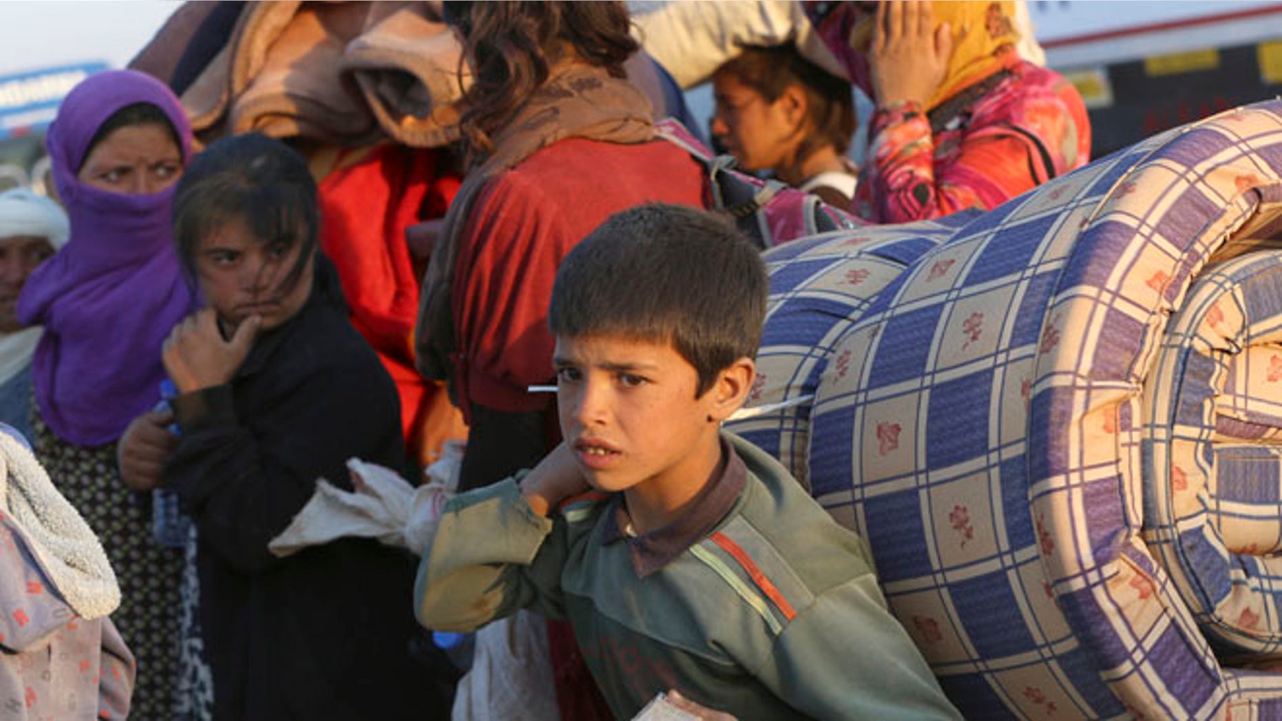 Sept. 23, 2014: Thousands of Syrian refugees enter Turkey at Yumurtalik crossing gate near Suruc